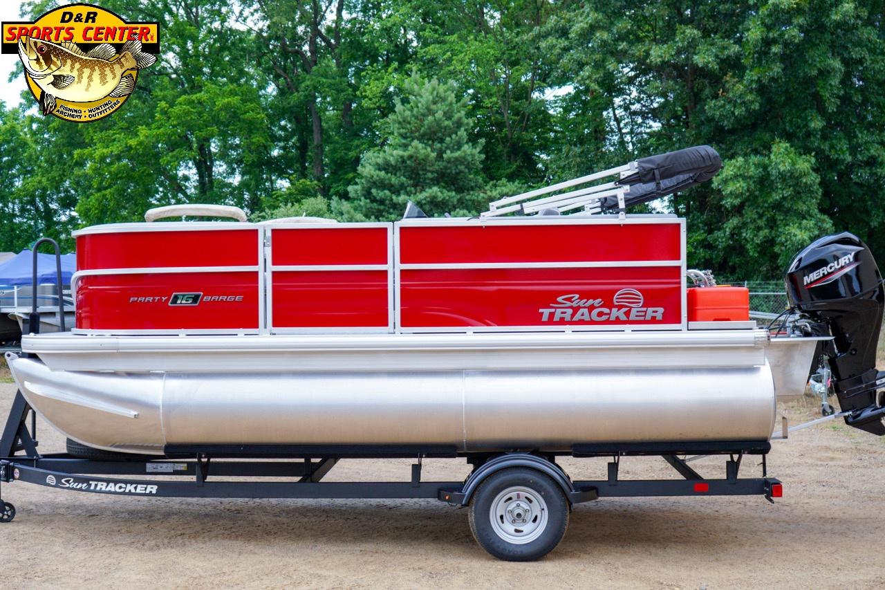 2026 Sun Tracker Party Barge 16 pontoon boat on trailer, red and silver design, outdoor setting.