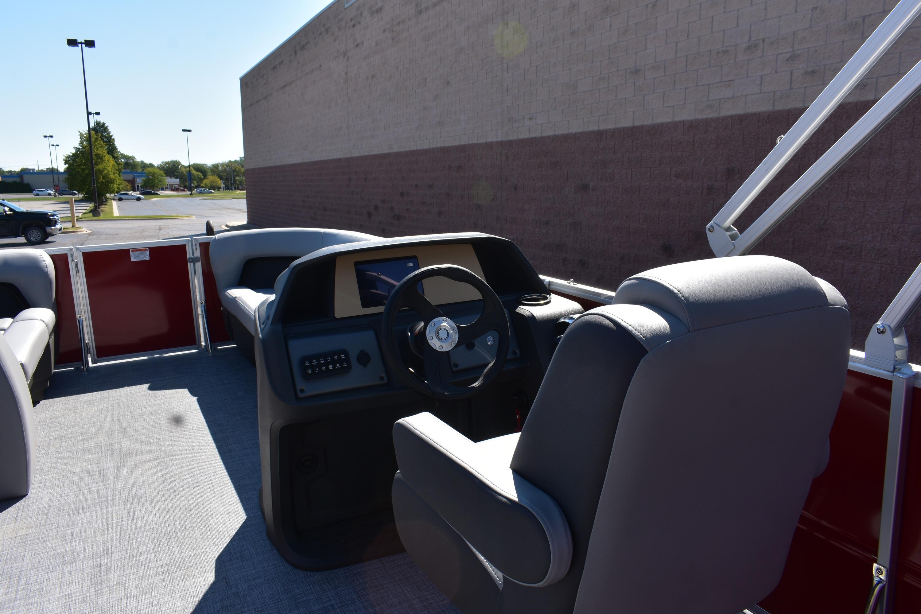 2026 Sun Tracker Party Barge 18 DLX interior with steering console and seating.