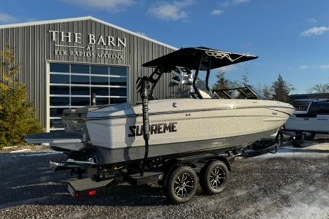 2026 Supreme S220 boat at Elk Rapids Marina, parked on a trailer.