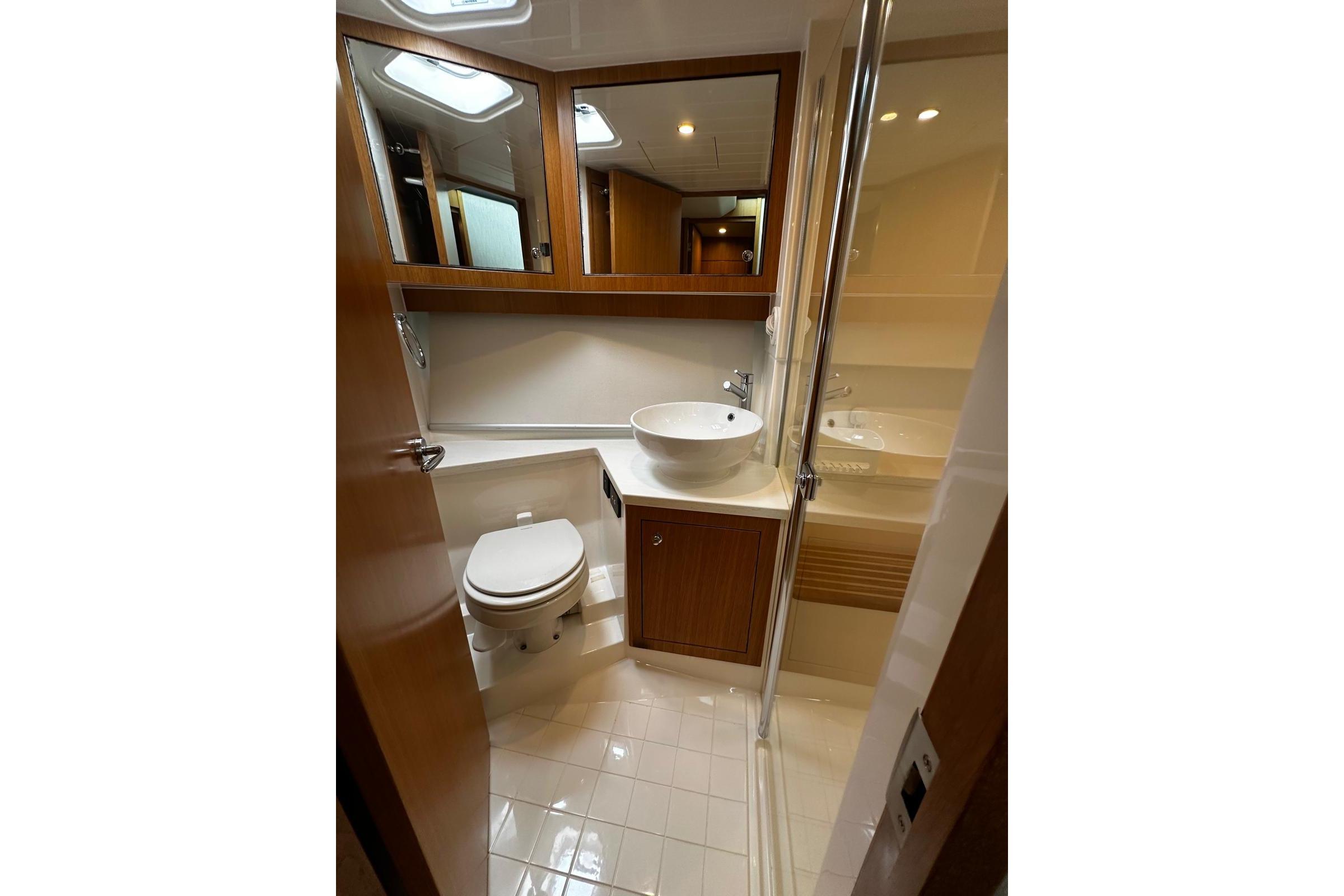 Luxurious bathroom in 2020 Riviera 395 SUV yacht with modern fixtures and elegant design.