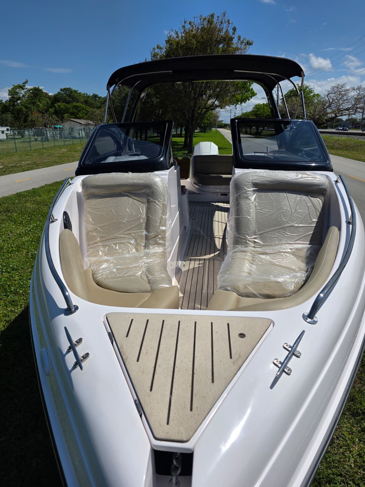 The image shows a modern boat with two seats and an open deck.