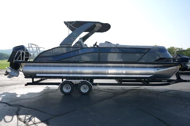 2025 Harris Grand Mariner 250 pontoon boat on trailer, sleek design, outdoor setting.