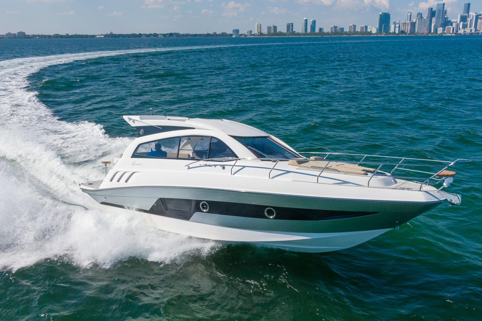 2026 Hanover 375 yacht cruising on open water with city skyline in background.