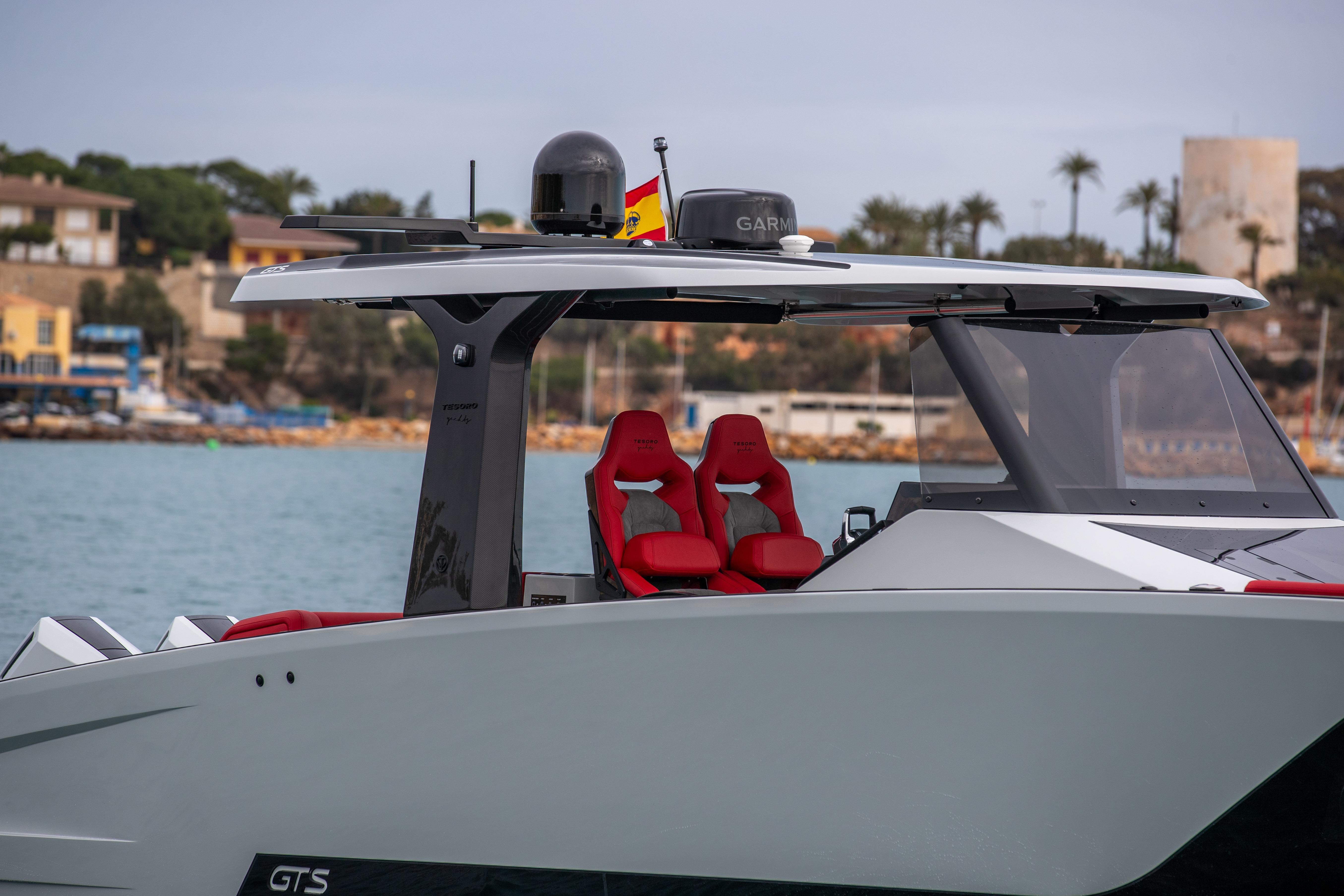 Tesoro 40 GTS 2026 boat with red seats at the harbor.