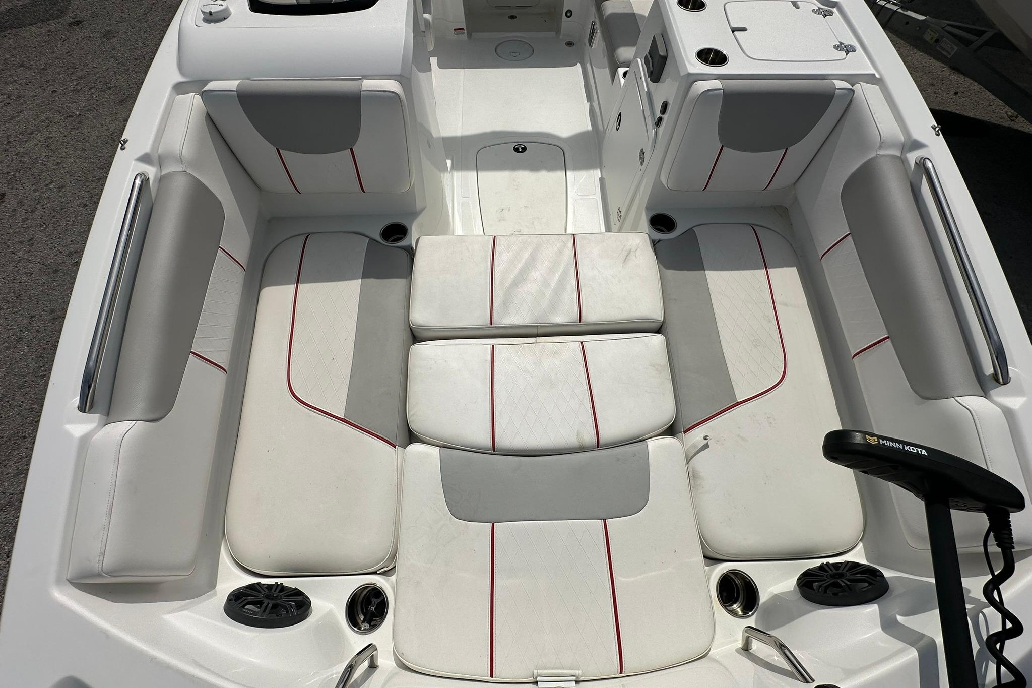 Interior of a 2021 Tahoe 2150 boat with white seating and red accents.