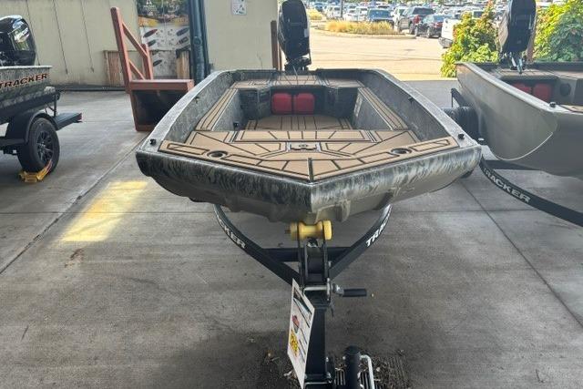 2026 Tracker Grizzly 1650 T Prairie Wings Edition boat on trailer in a garage.