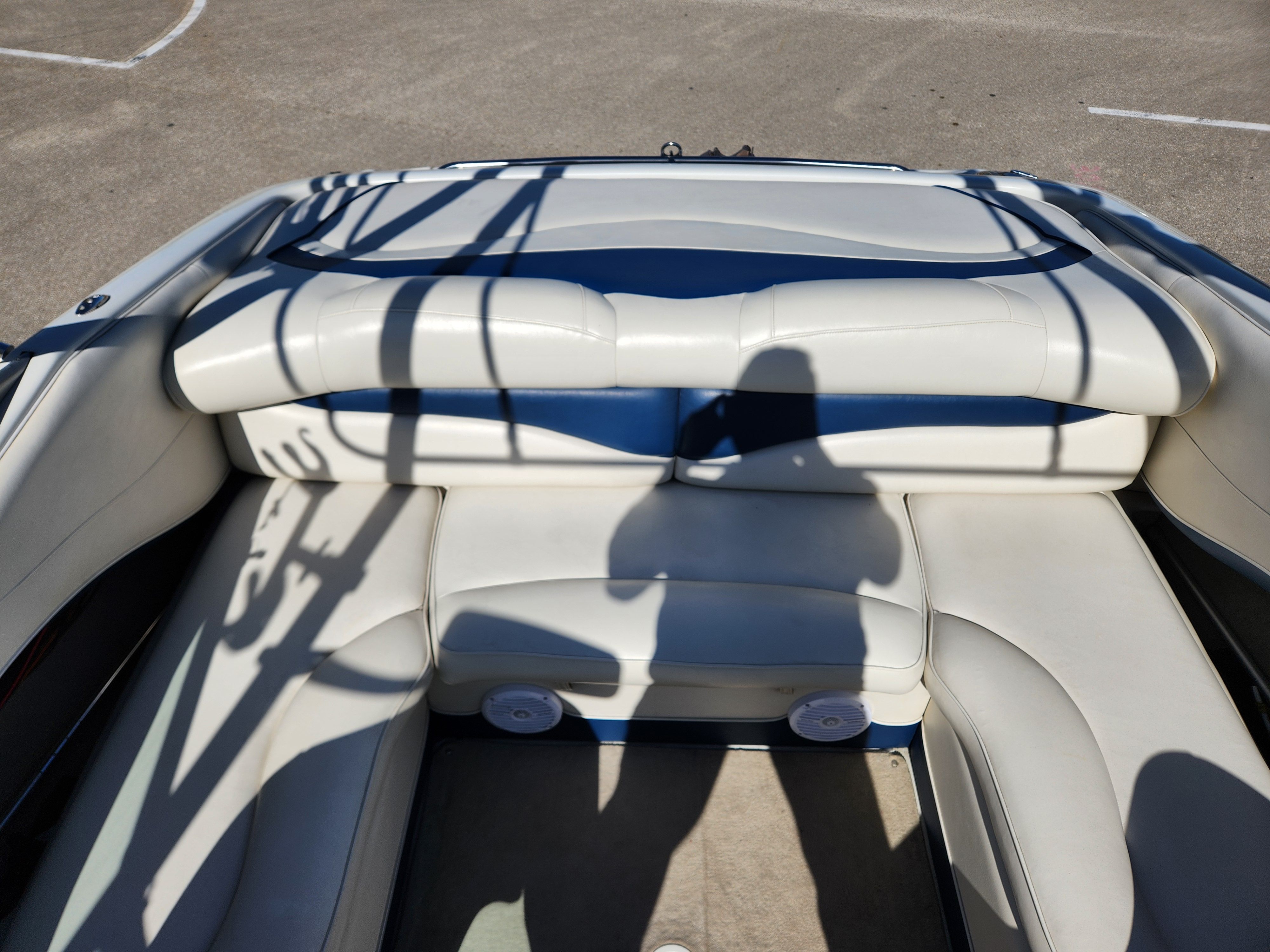 Interior of a 2003 Crownline 225 BR boat with white seating.