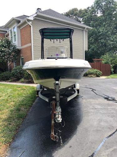 2003 Wellcraft 180 Fisherman boat on trailer in residential driveway.