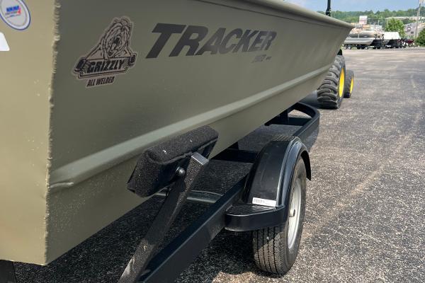 2025 Tracker GRIZZLY 2072 Utility boat on trailer, side view, outdoors.