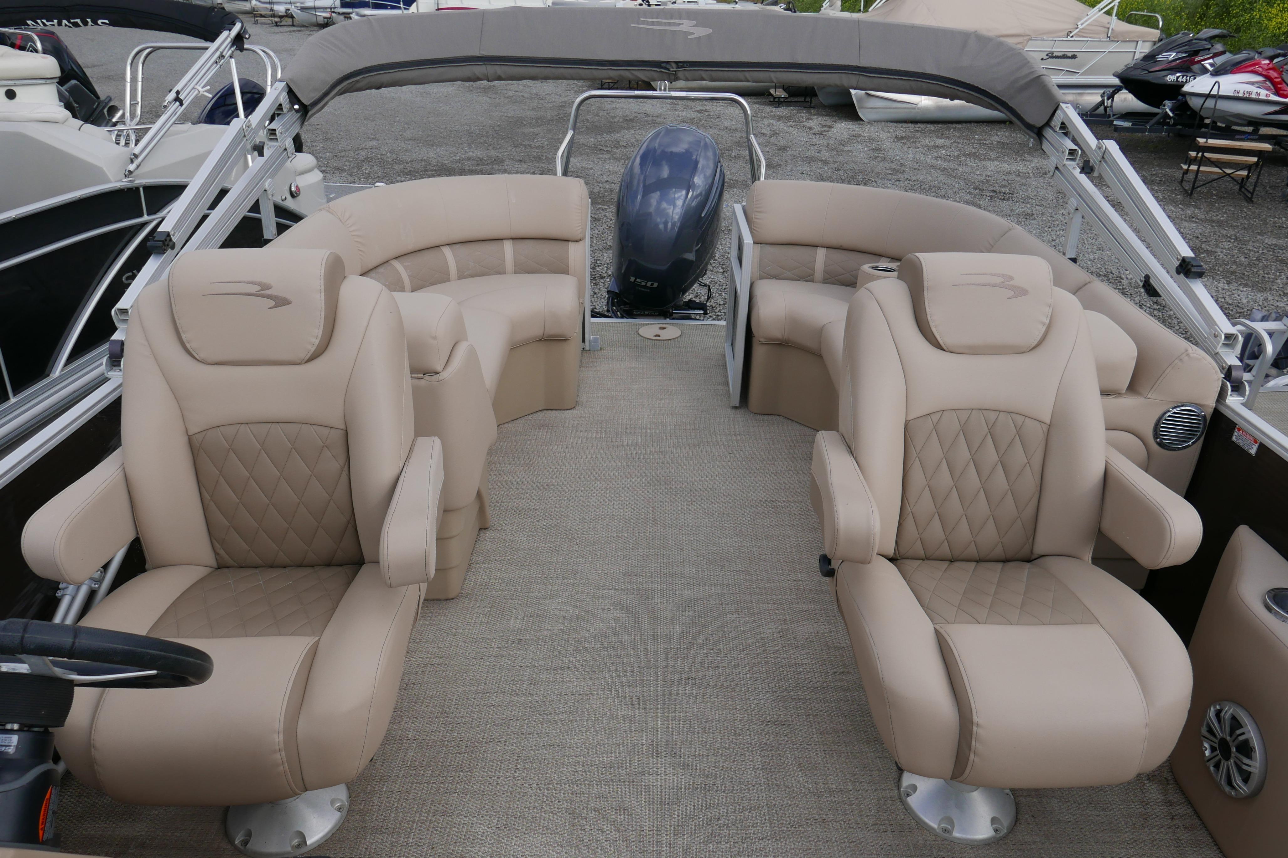 2018 Bennington 22 SSRX pontoon boat interior with beige seating and spacious layout.