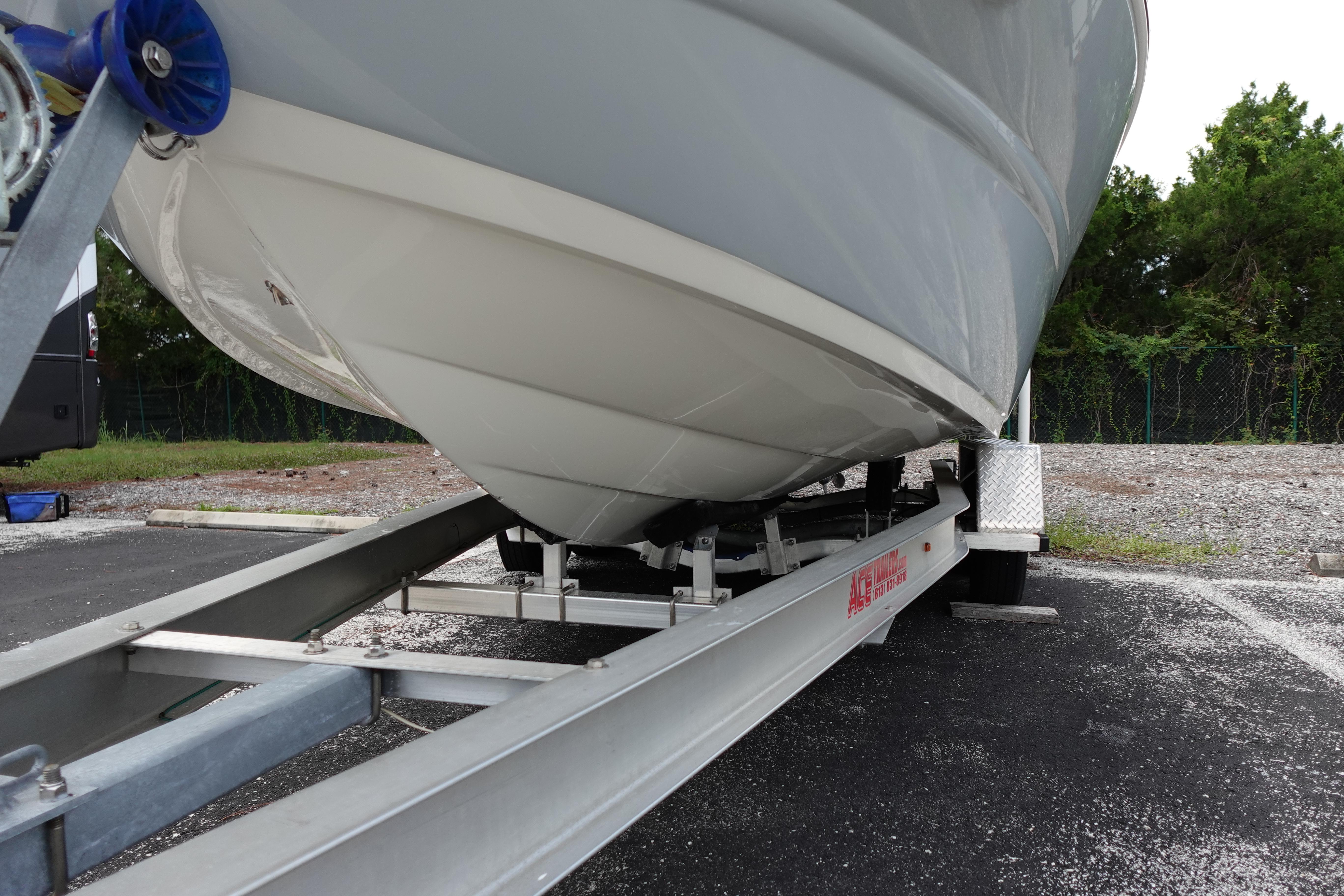 2022 Stingray 231 DC boat on trailer, parked outdoors.