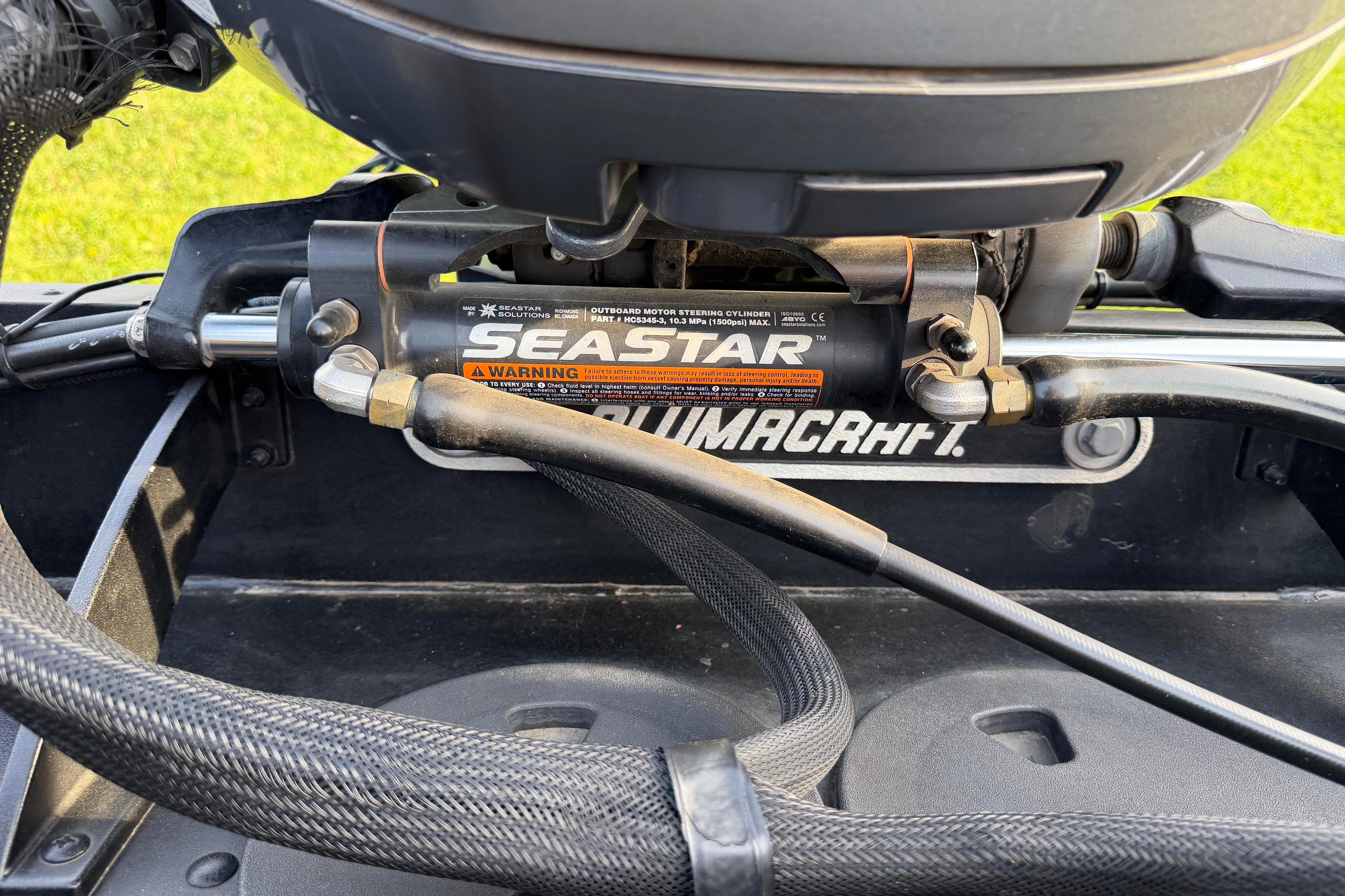 Close-up of 2019 Alumacraft Trophy 205 boat steering mechanism with SeaStar hydraulic system.
