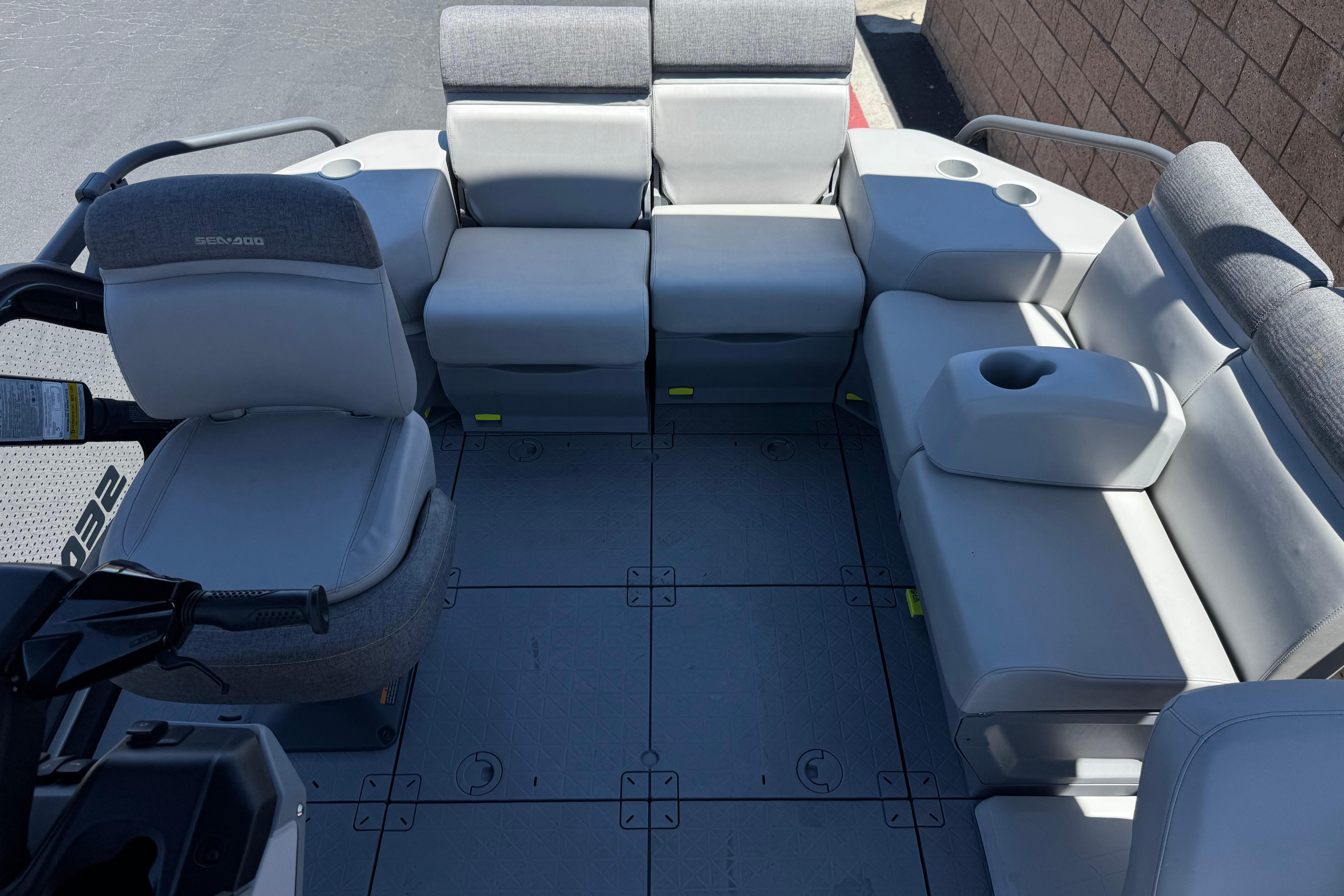 2024 Sea-Doo Switch Compact interior with gray seating and cup holders.