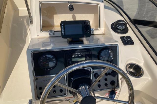 2023 Scout 210 Dorado boat dashboard with steering wheel and navigation equipment.