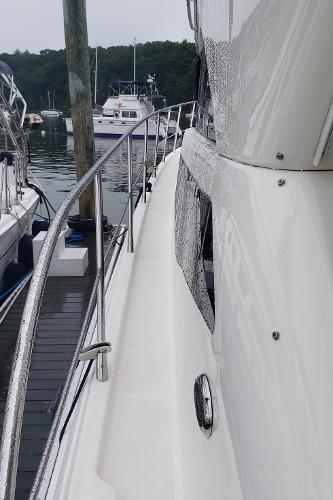 2010 Meridian 441 Sedan yacht docked at marina, side view.