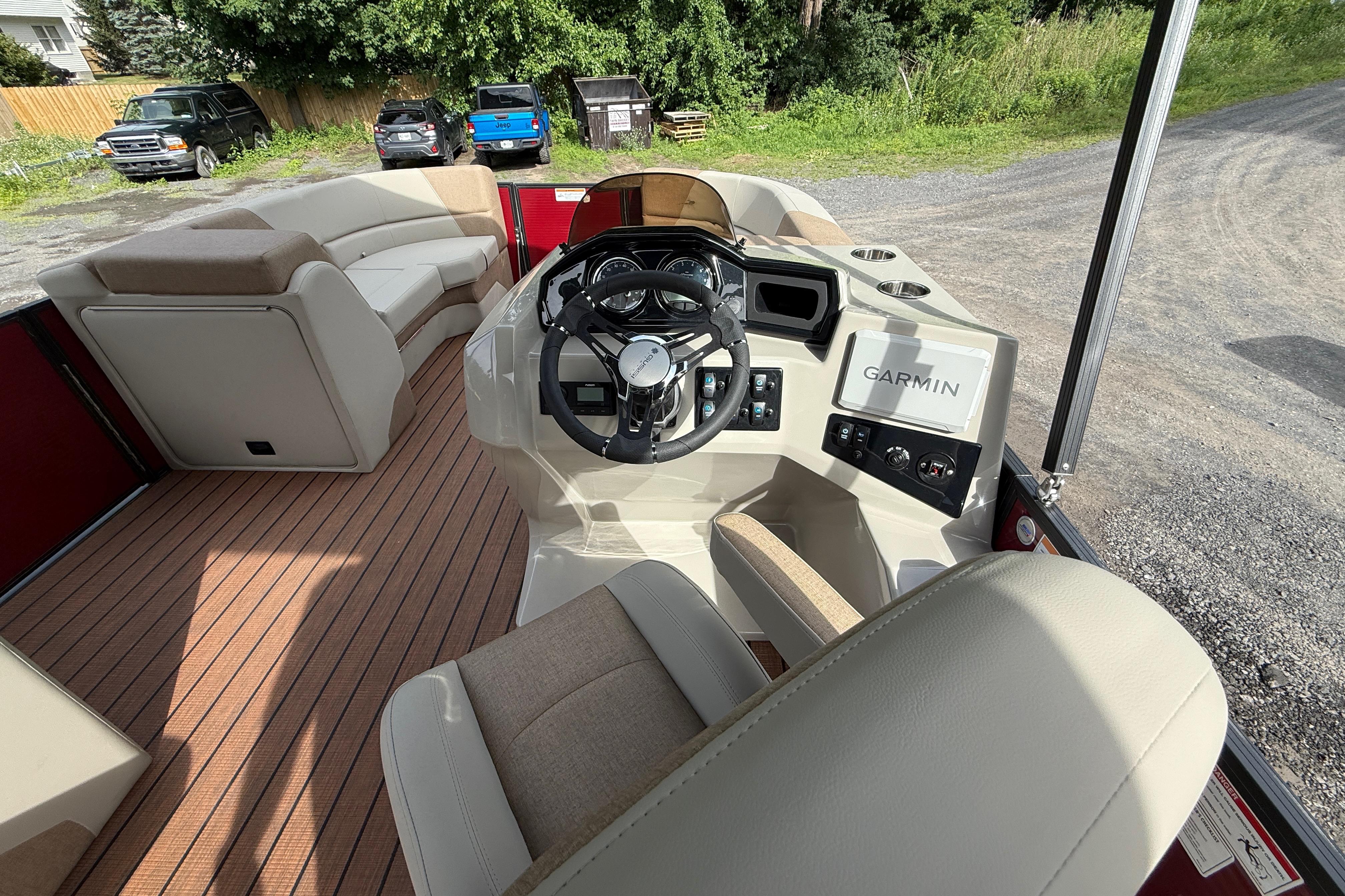 Interior of 2027 Manitou 21 Aurora LE boat with Garmin navigation system.