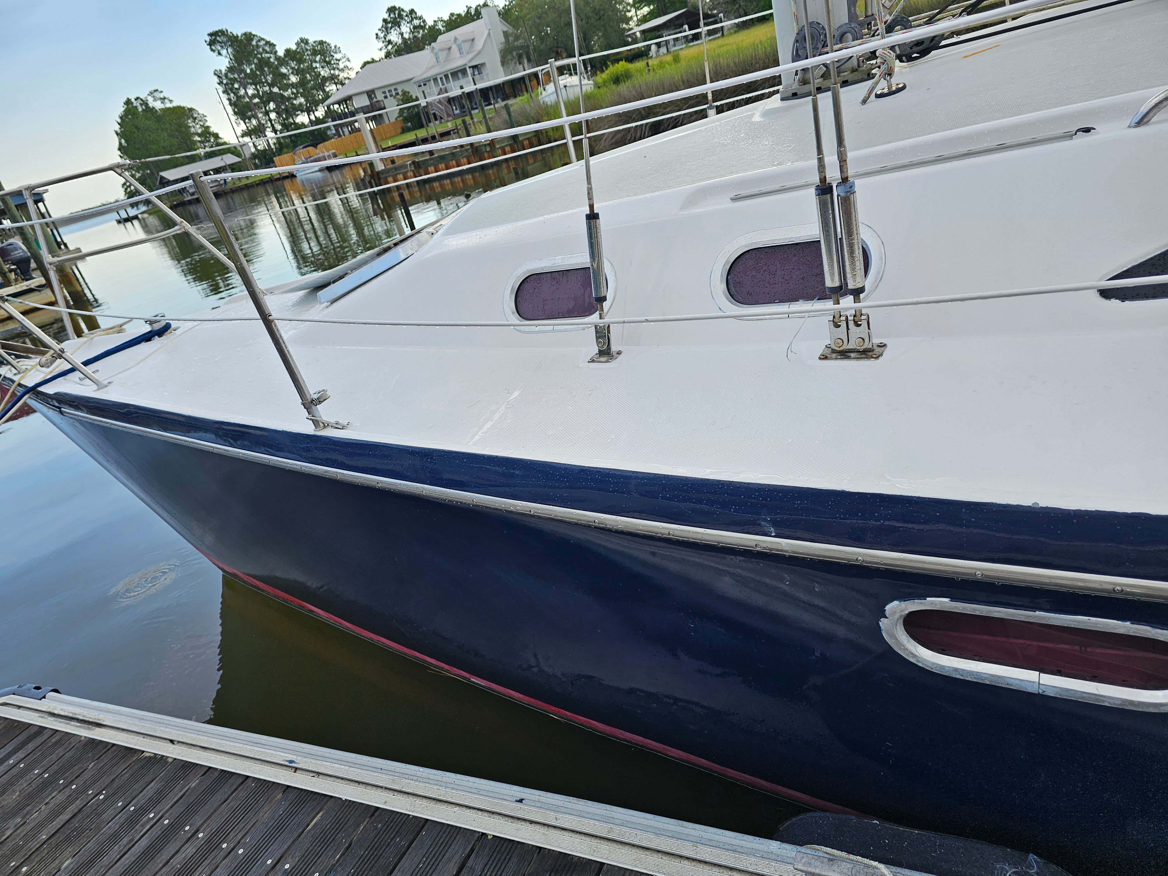 2006 Catalina 320 sailboat docked, calm water setting.