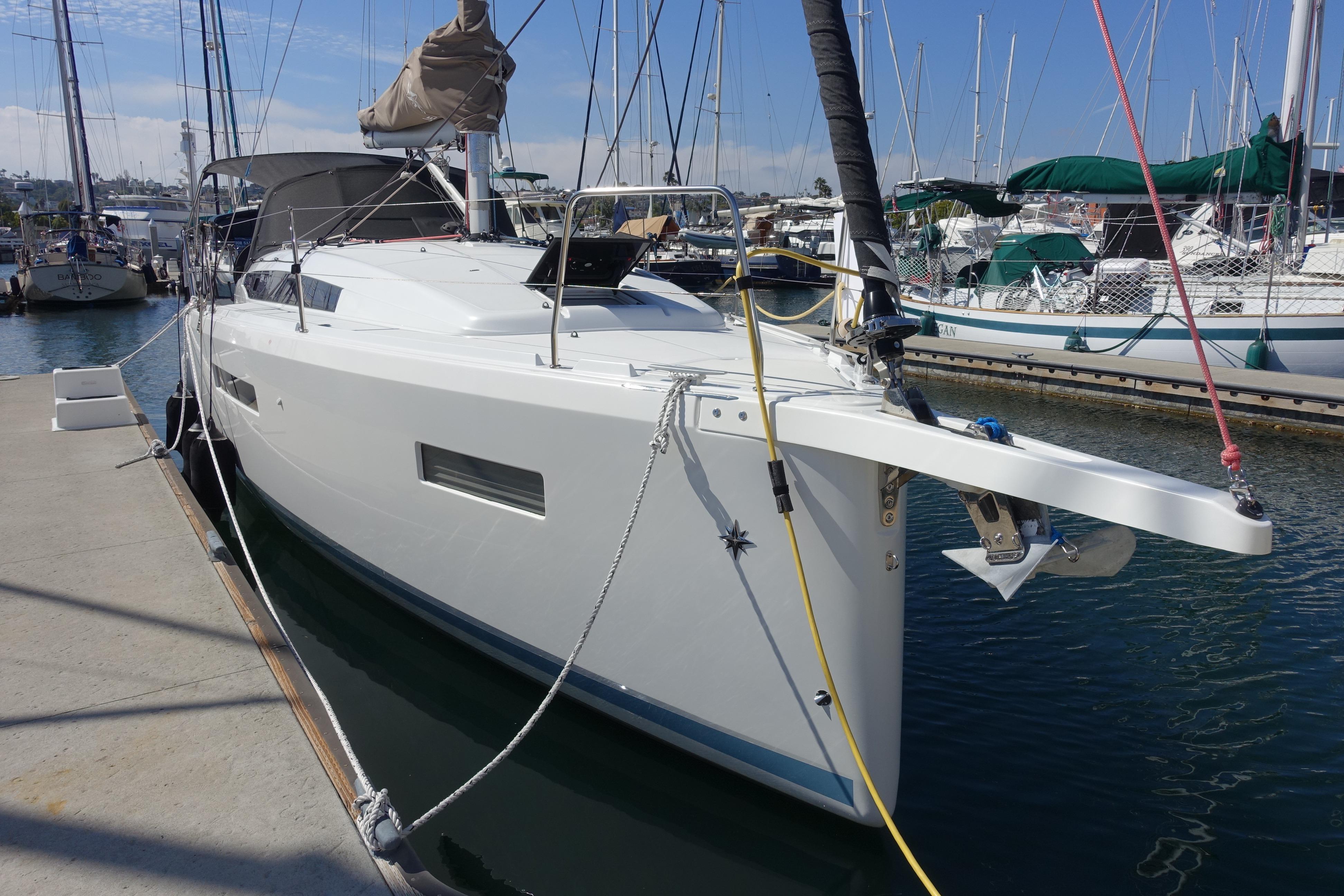2023 Jeanneau Sun Odyssey 380 yacht docked at marina, showcasing sleek design and modern features.