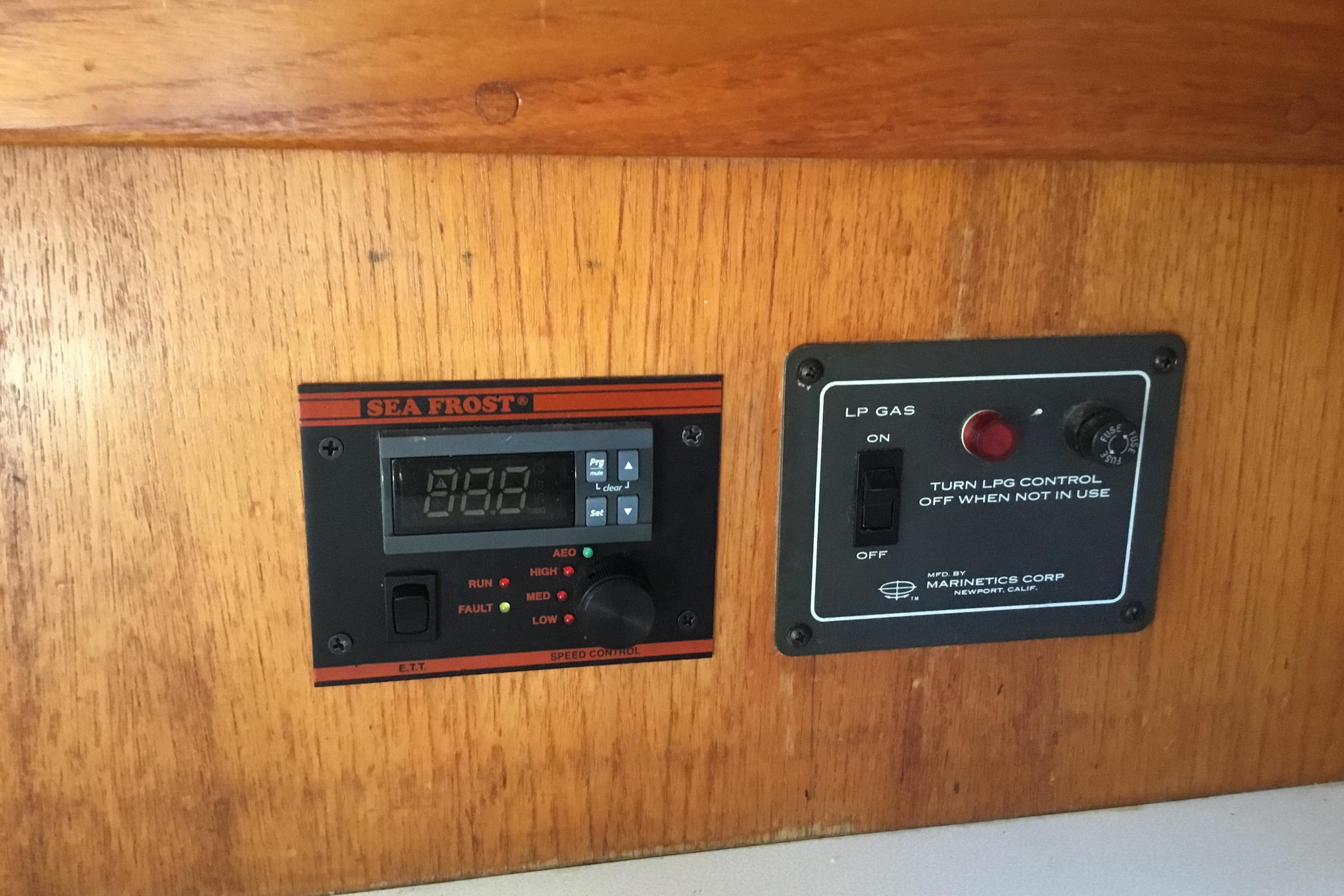 Control panels on a 1977 Gulfstar 37 yacht, featuring Sea Frost and LP gas systems.