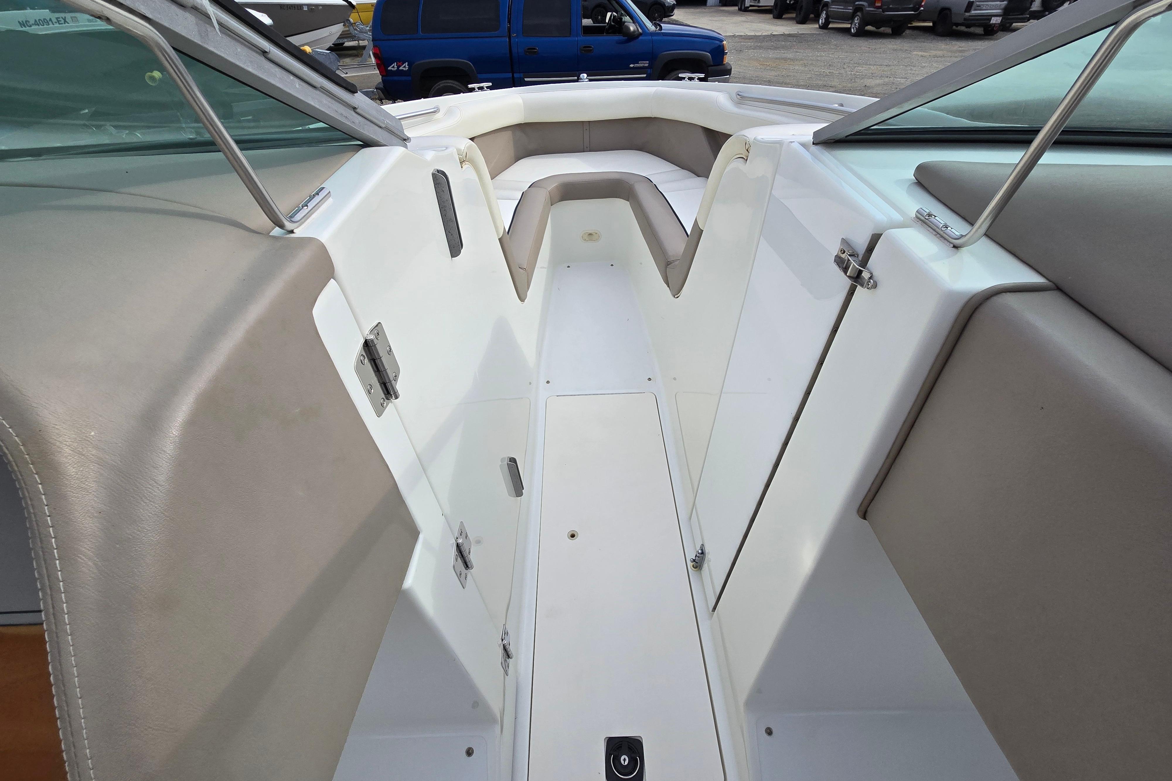 Interior view of a 2000 Cobalt 246 boat, featuring beige seating and white deck.