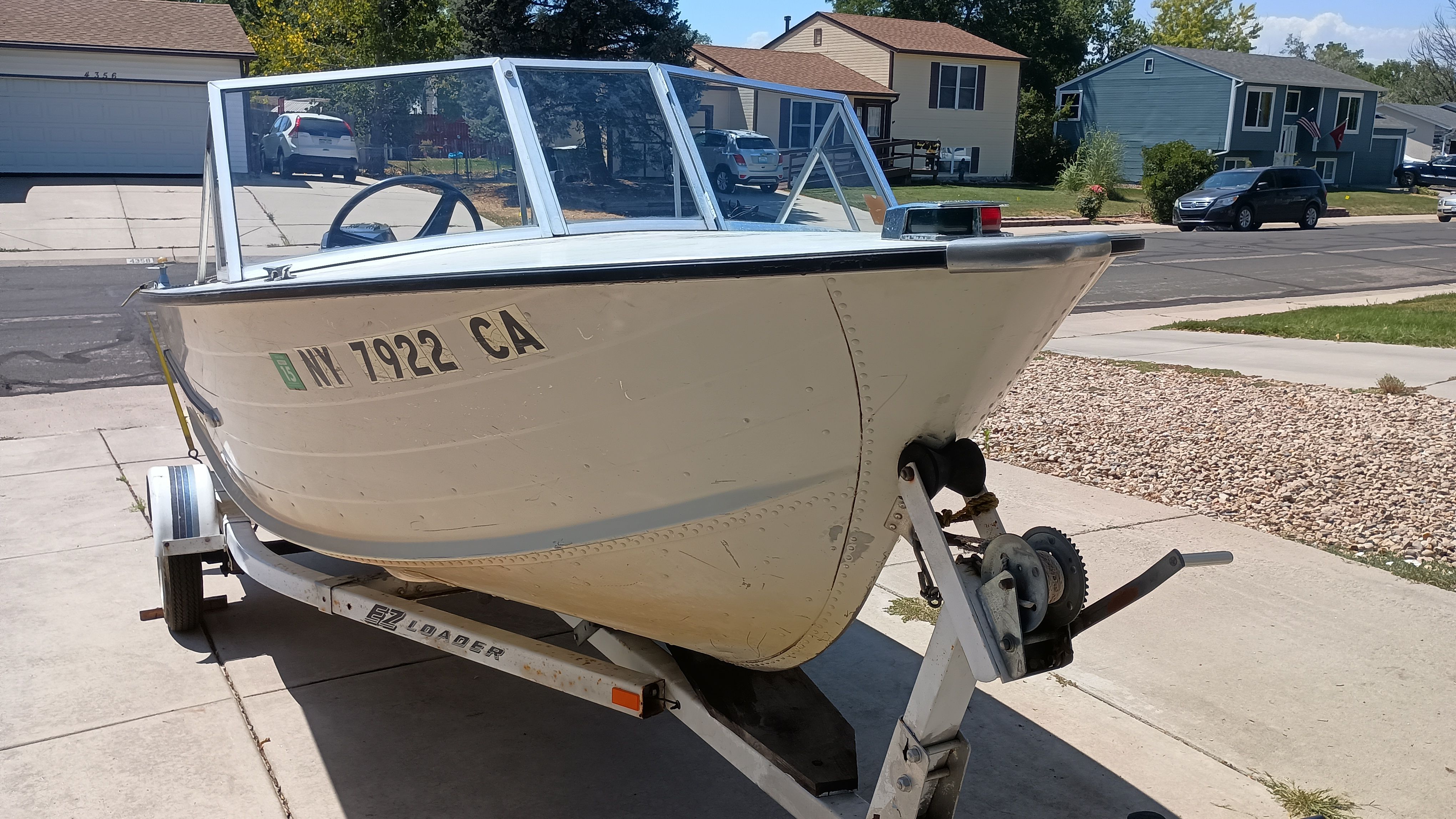 1970 Starcraft Jupiter V boat on trailer in residential area.