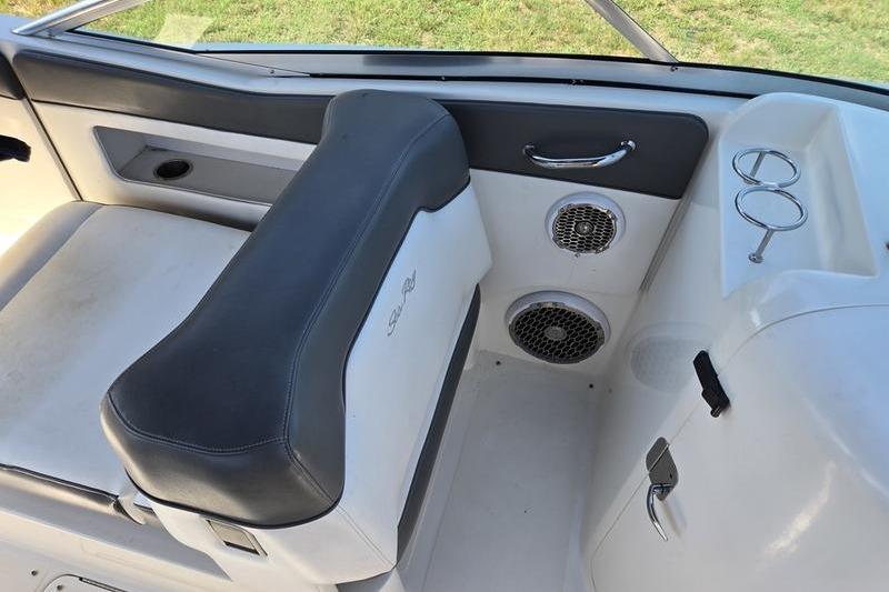 Interior of a 2011 Sea Ray 300 Sundeck boat with seating and cup holders.