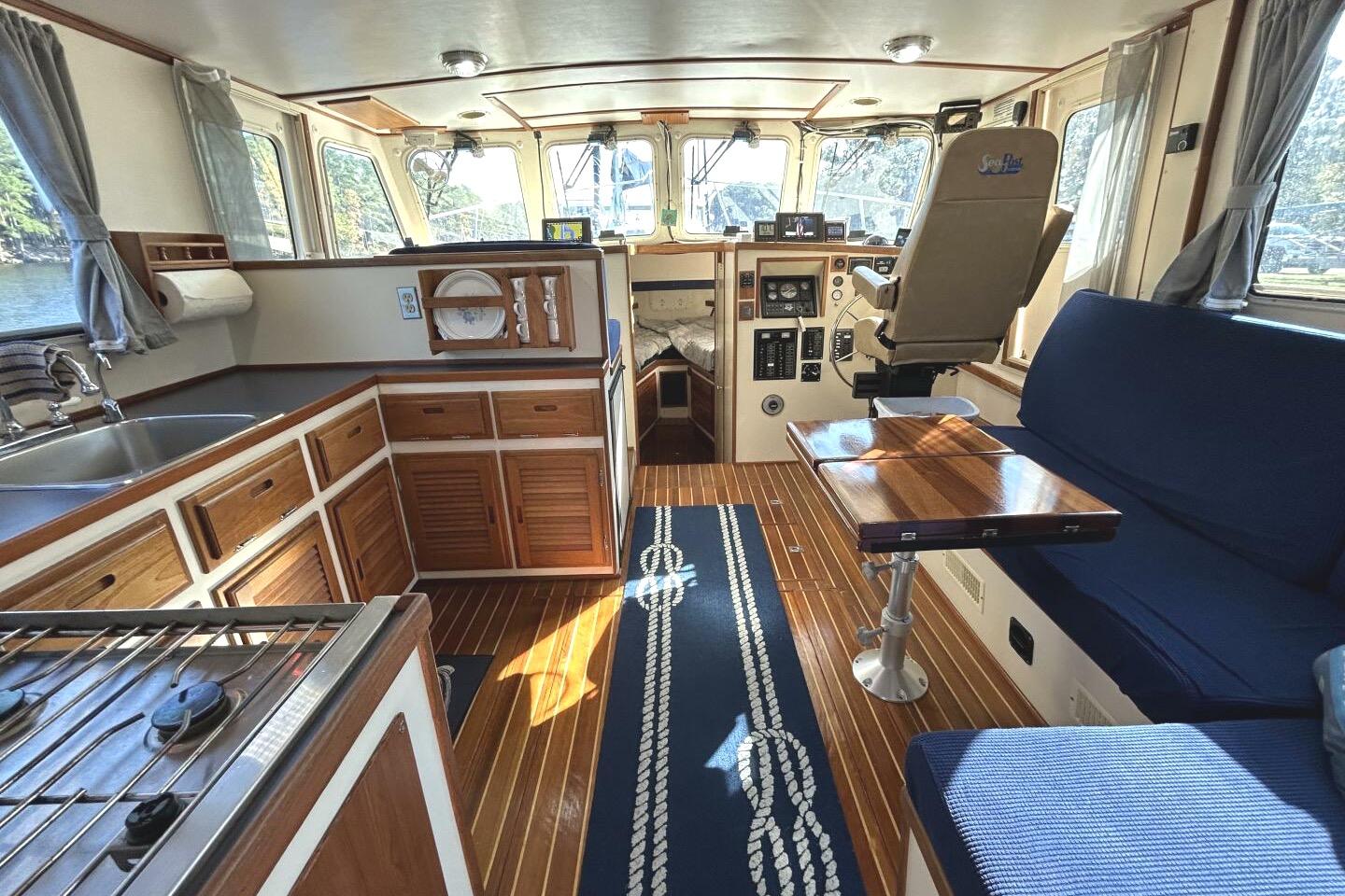 Interior of a 1997 Rosborough Trawler with wood accents and nautical decor.