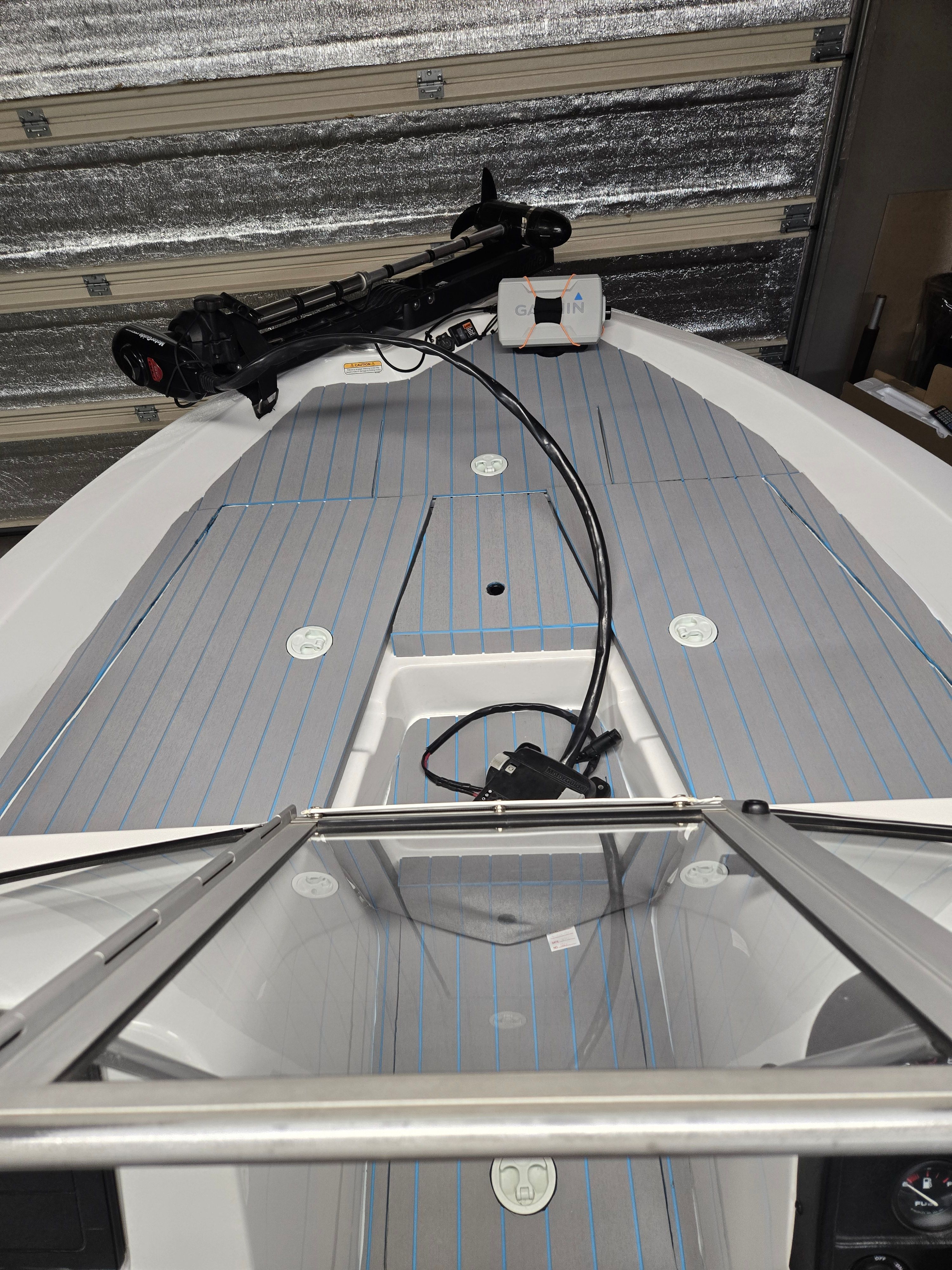ProCraft 170 Combo 2007 with gray deck and blue stripes, stored in a garage.