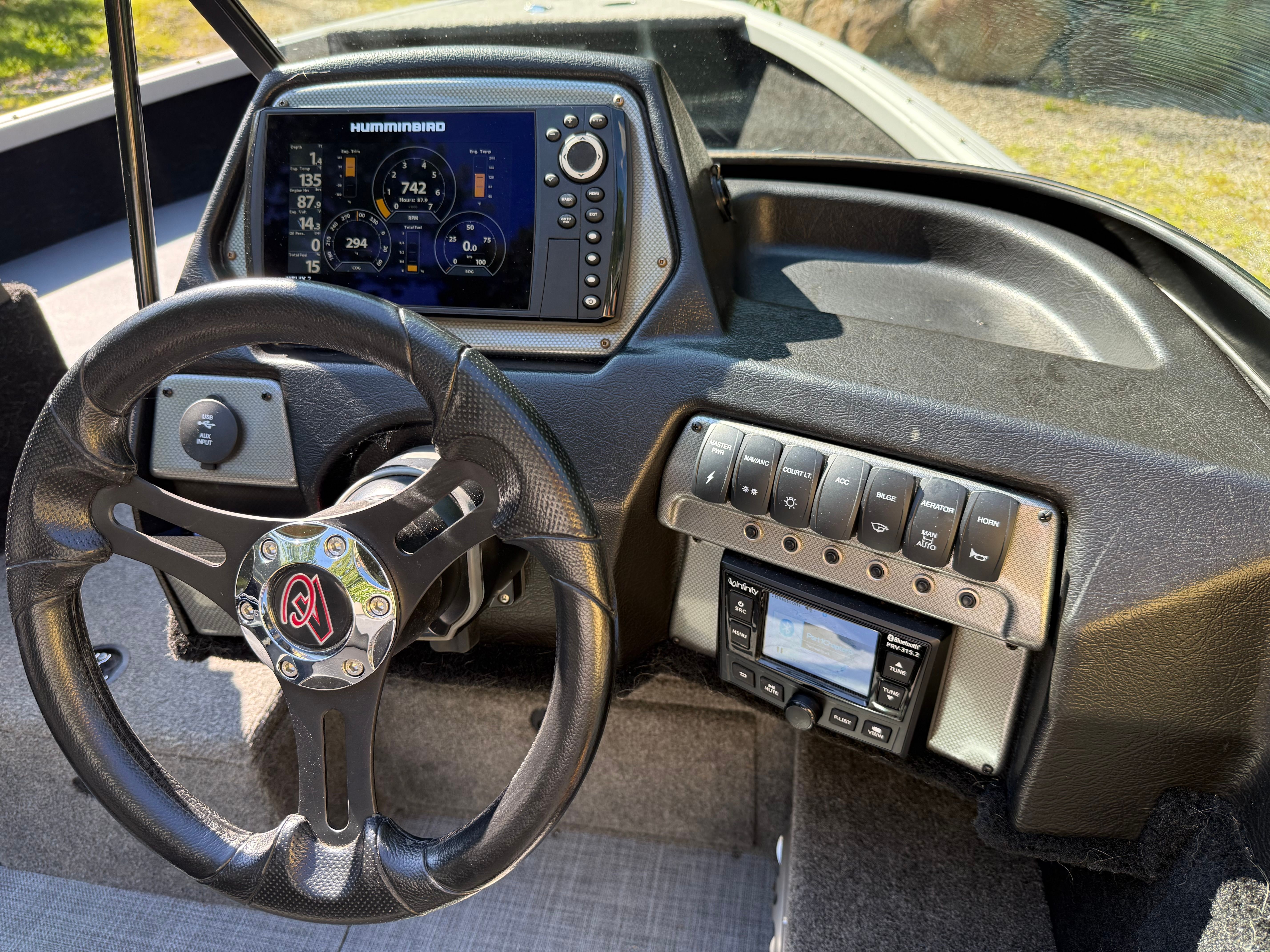 Dashboard of an Alumacraft Competitor 175 Sport with steering wheel and electronics.