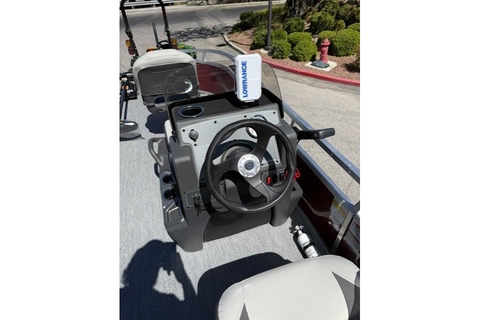 2026 Sun Tracker Bass Buggy 16 XL Select boat dashboard with steering wheel and Lowrance device.