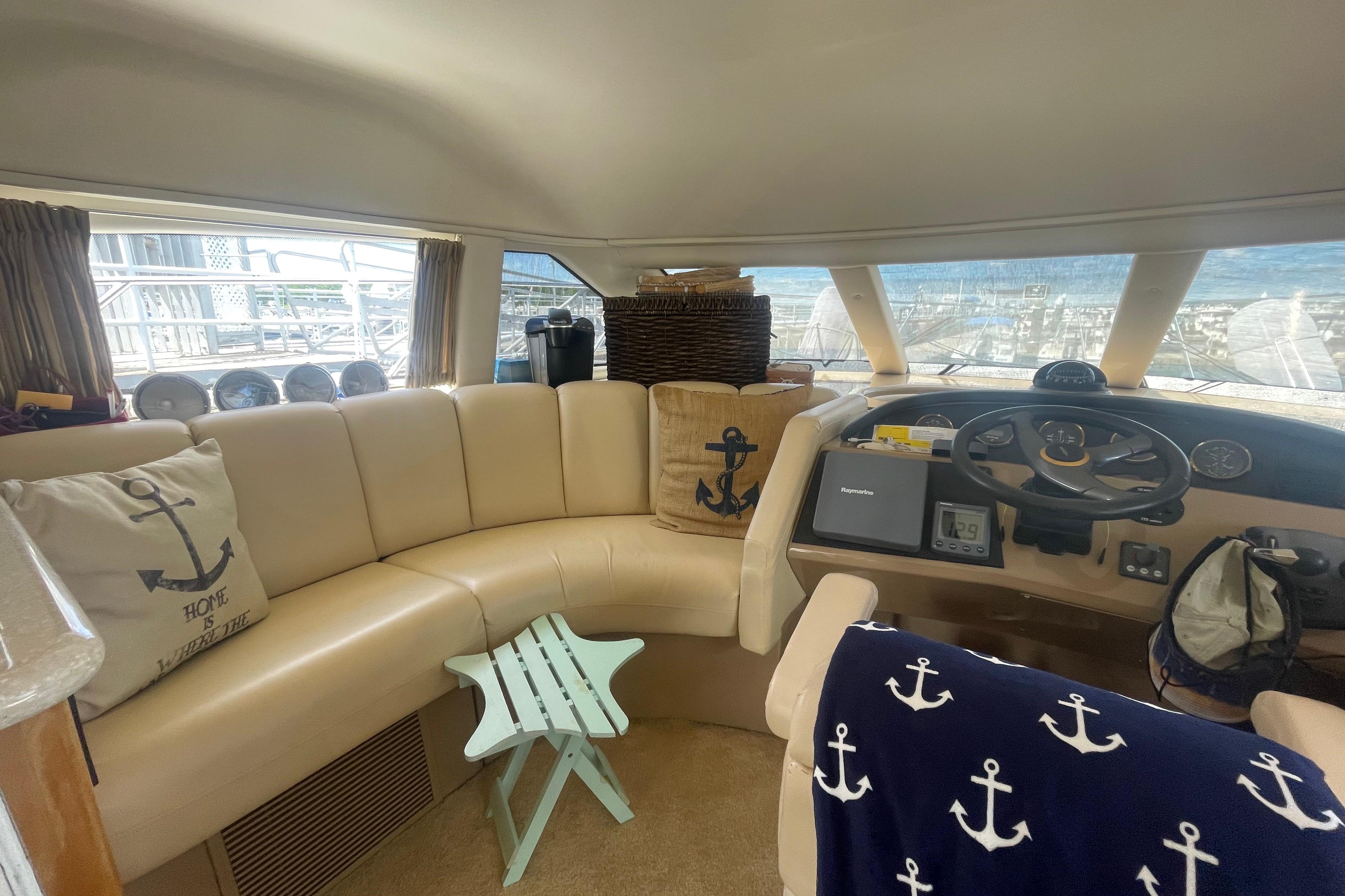 Interior of 2002 Carver 410 Sport Sedan with nautical decor and helm station.