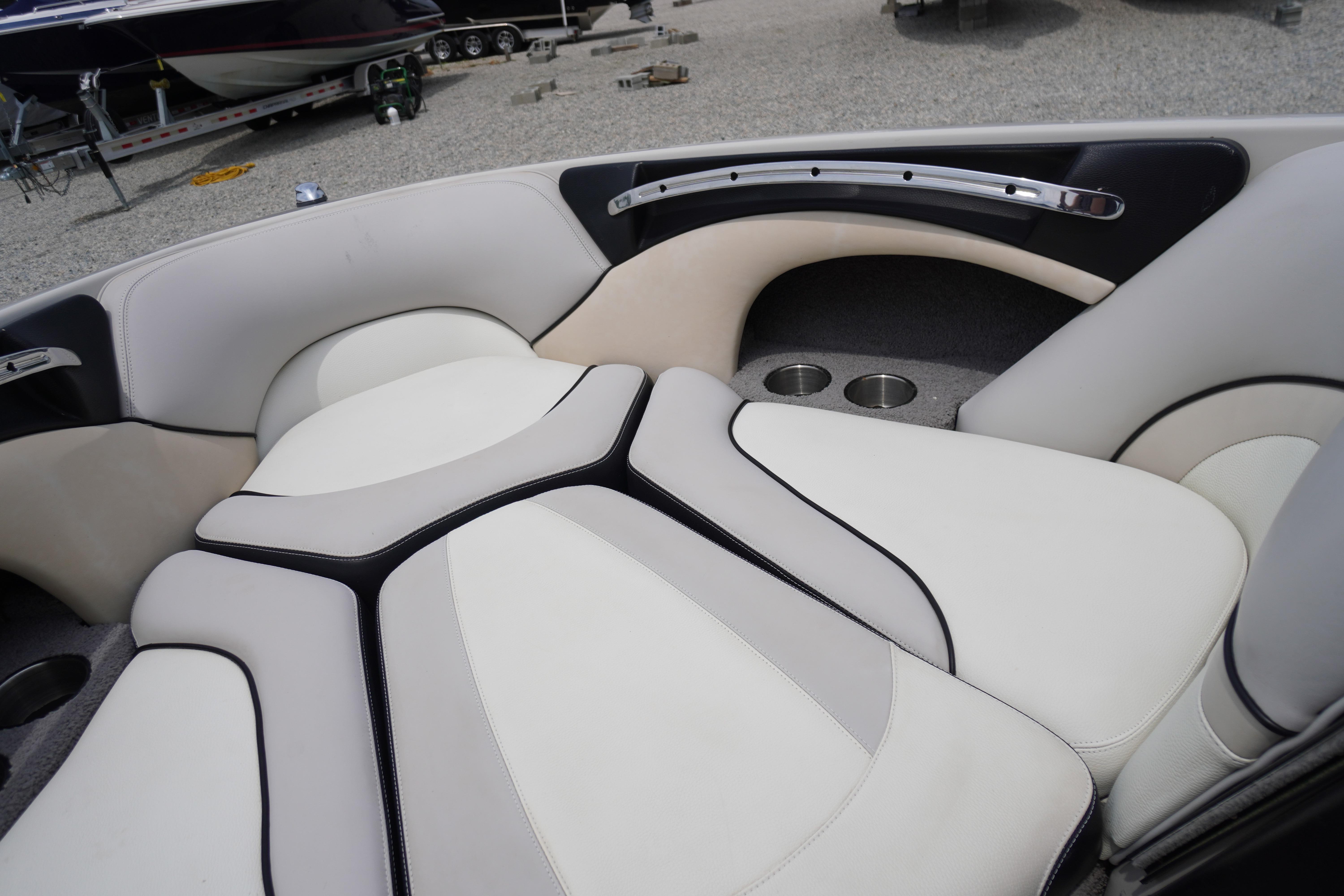 Interior seating of a 2011 Malibu Wakesetter 21 VLX boat, featuring sleek design and cup holders.