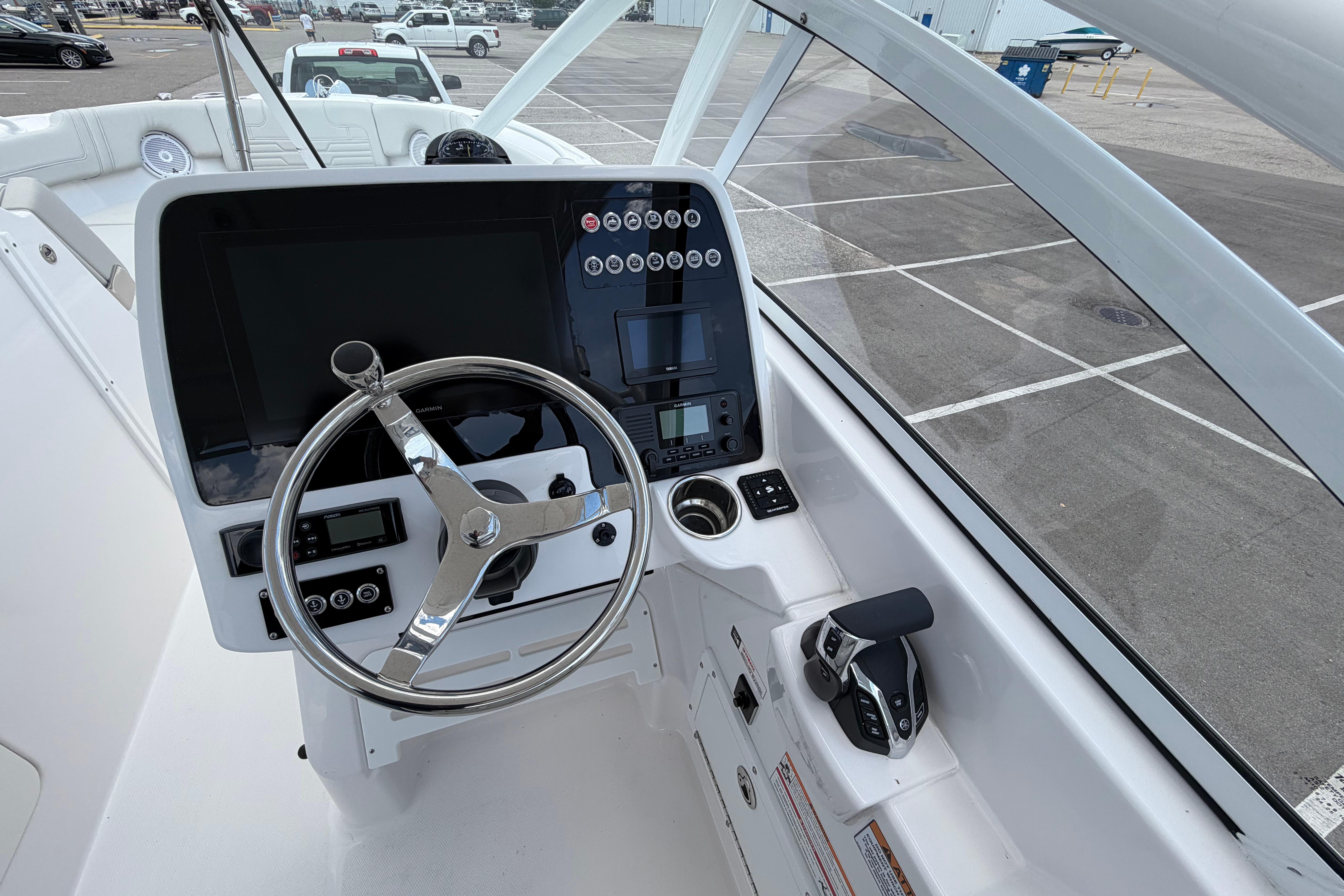 2026 Edgewater 248CX Crossover boat dashboard with steering wheel and control panel.