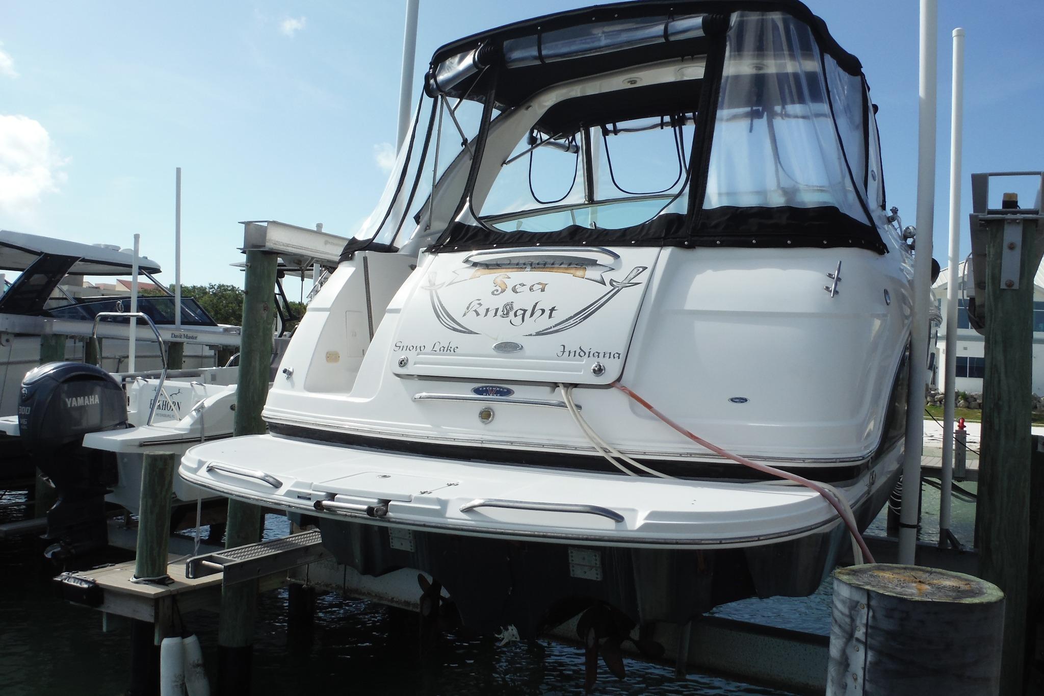 2005 Chaparral Signature 350 boat docked, rear view with canopy and name "Sea Knight."
