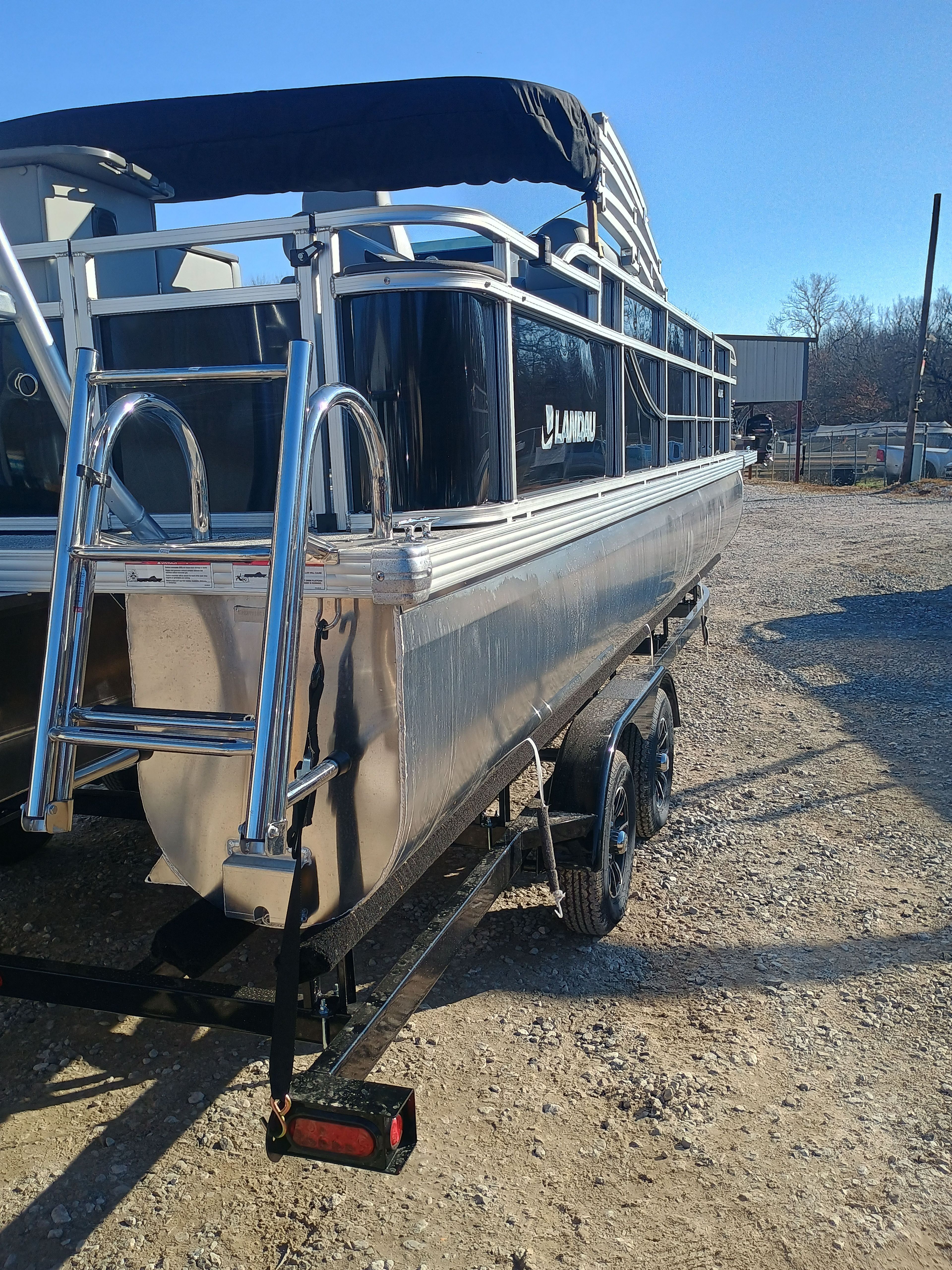 2026 Landau Alure 25CC Fish-Black boat on trailer, side view.