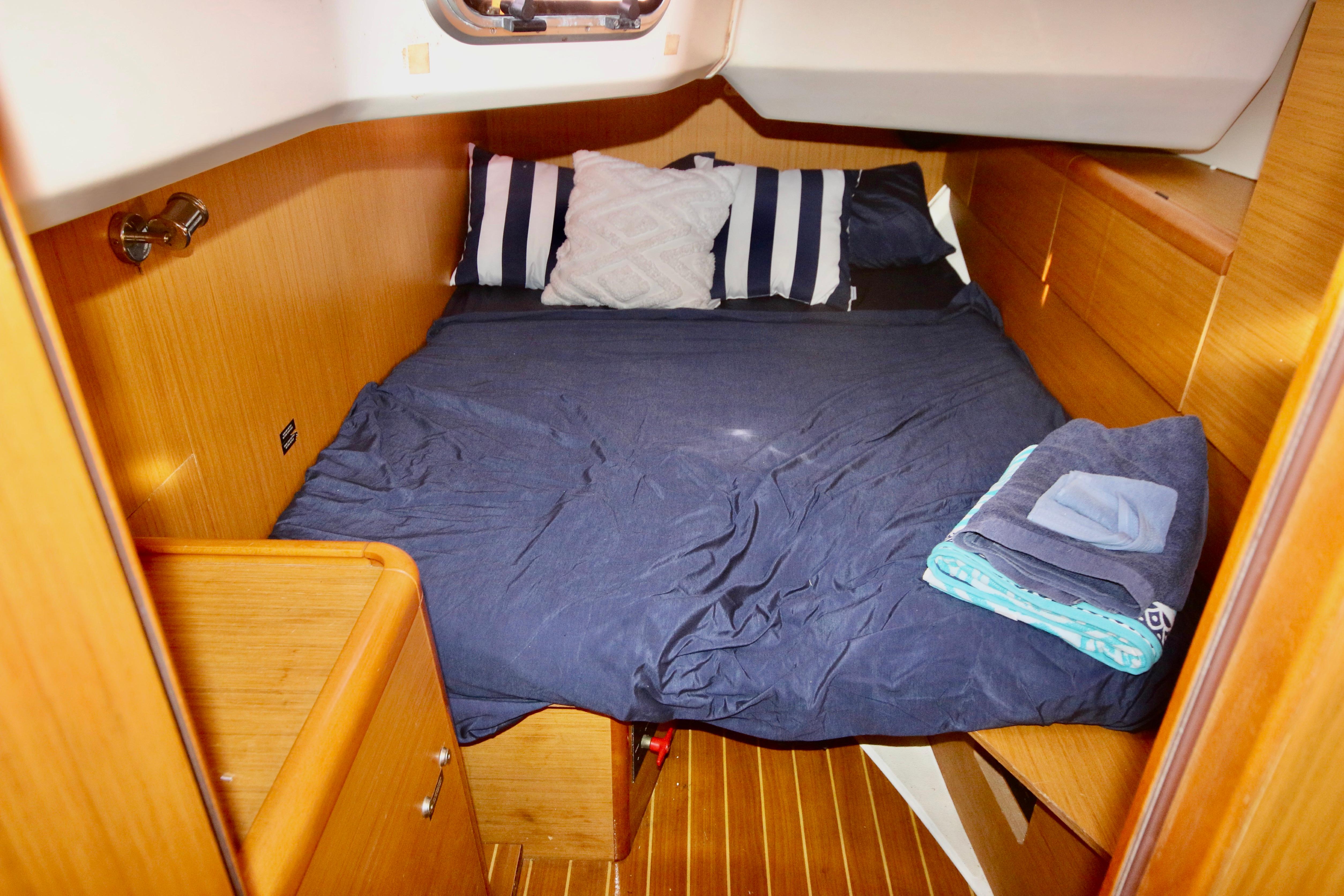 Cozy cabin interior of 2009 Jeanneau Sun Odyssey 44i with neatly arranged bedding.
