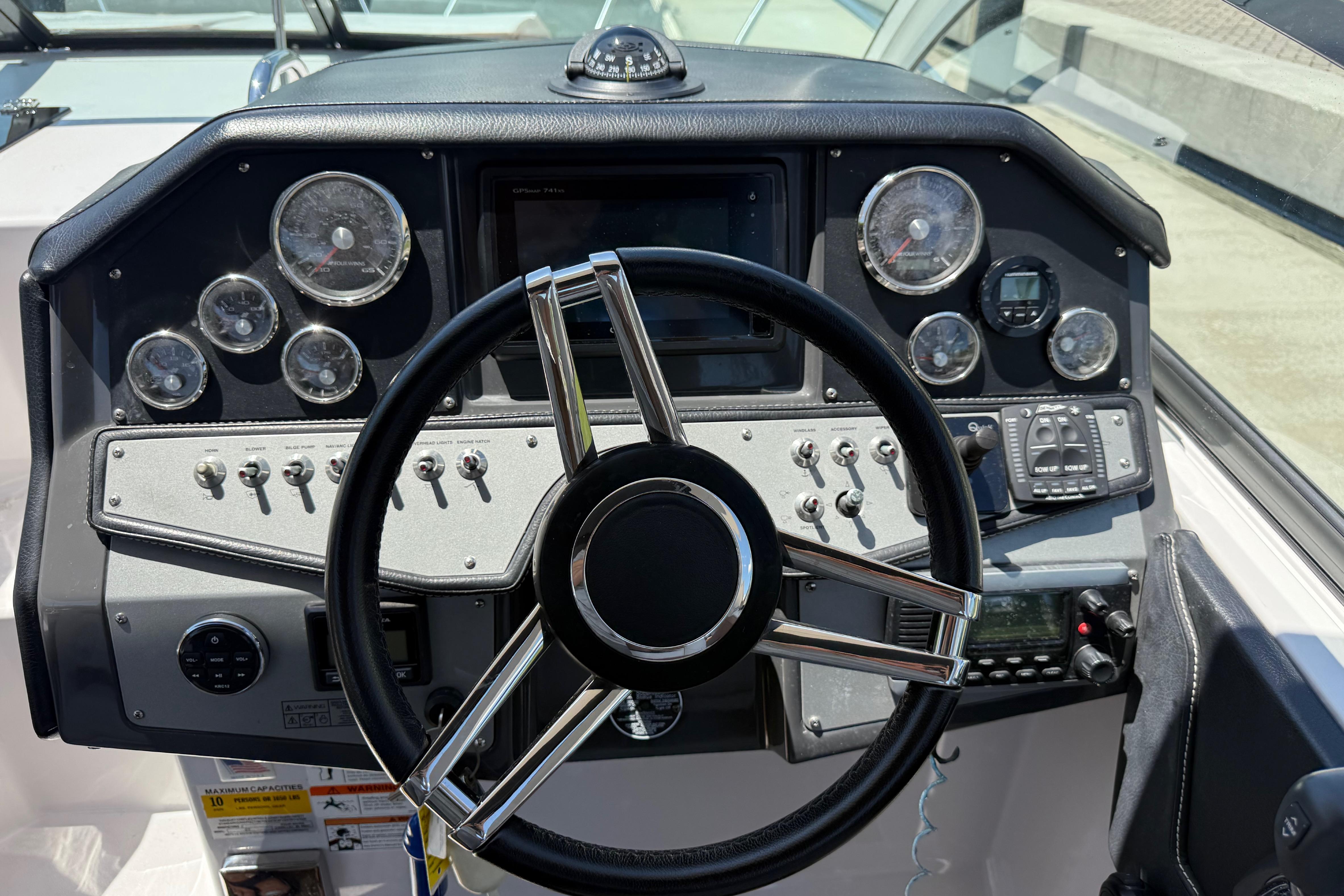 Dashboard of a 2017 Four Winns V275 boat with steering wheel and gauges.