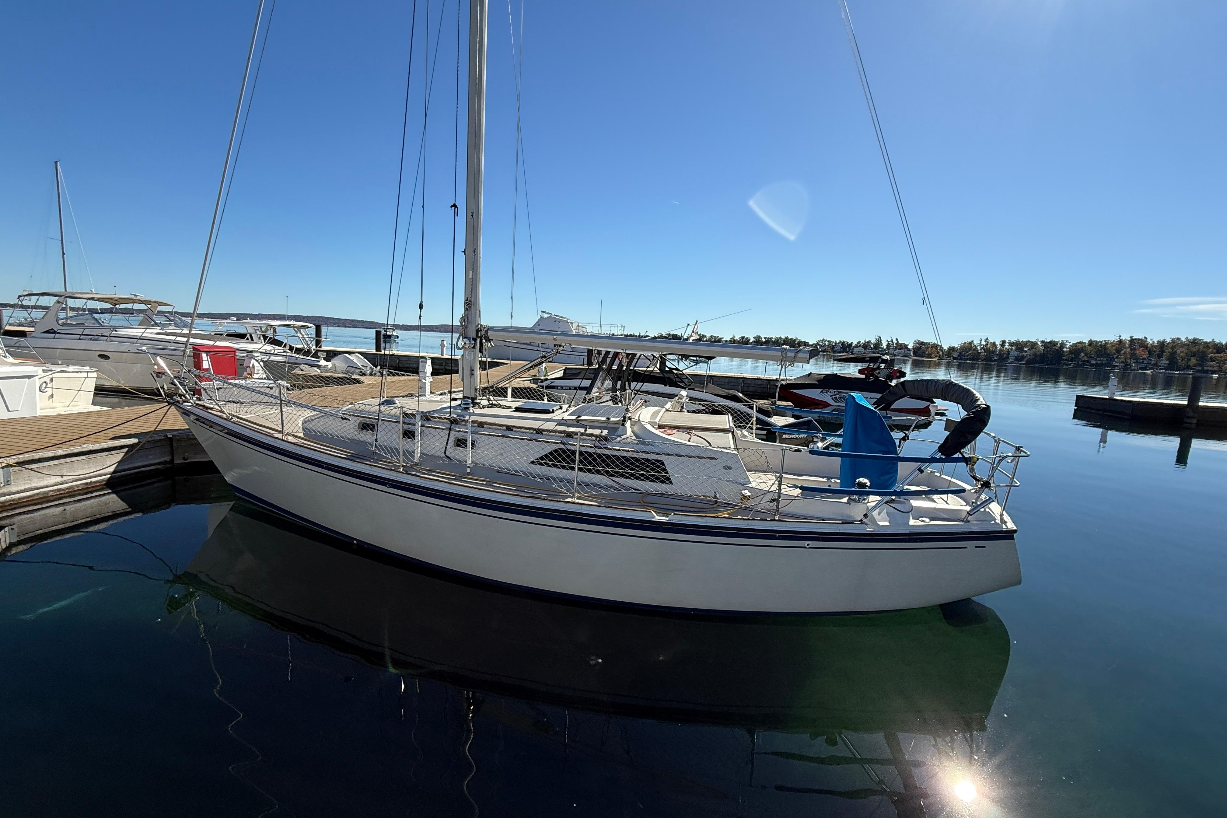 1983 O'Day 34 sailboat docked at a marina on a sunny day.