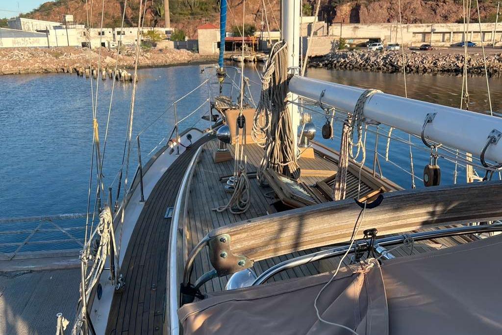 1983 Tayana 37 sailboat docked in a marina, showcasing deck and rigging.