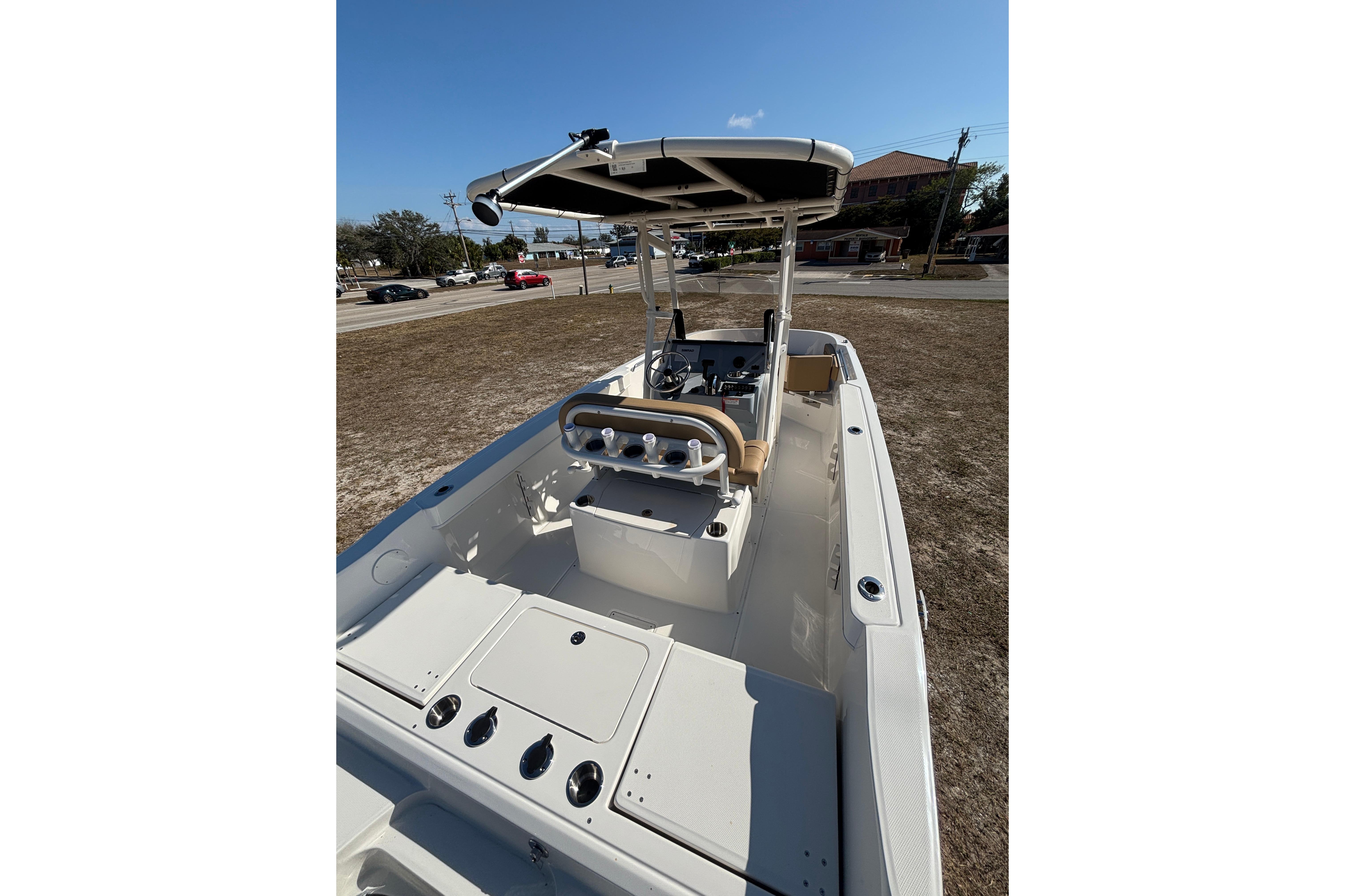 2026 Bayliner Trophy T22CC boat interior with console and seating, parked on land.
