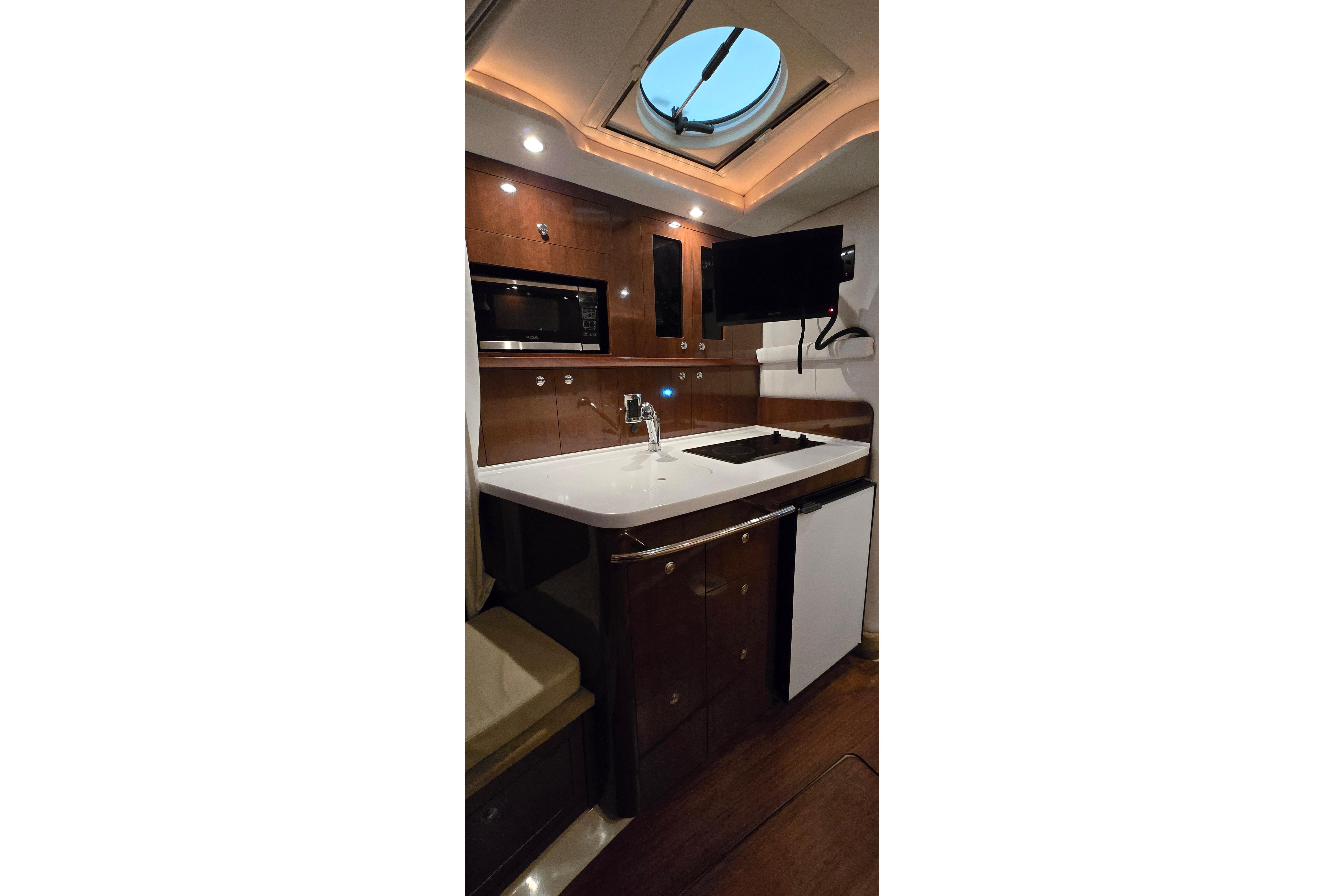 2018 Four Winns V355 yacht interior kitchen with modern appliances and sleek design.