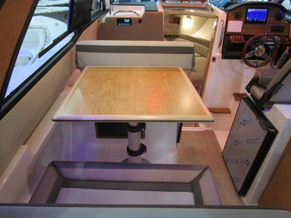 Interior of 2025 Cutwater C-248 Coupe featuring a dining area and helm station.