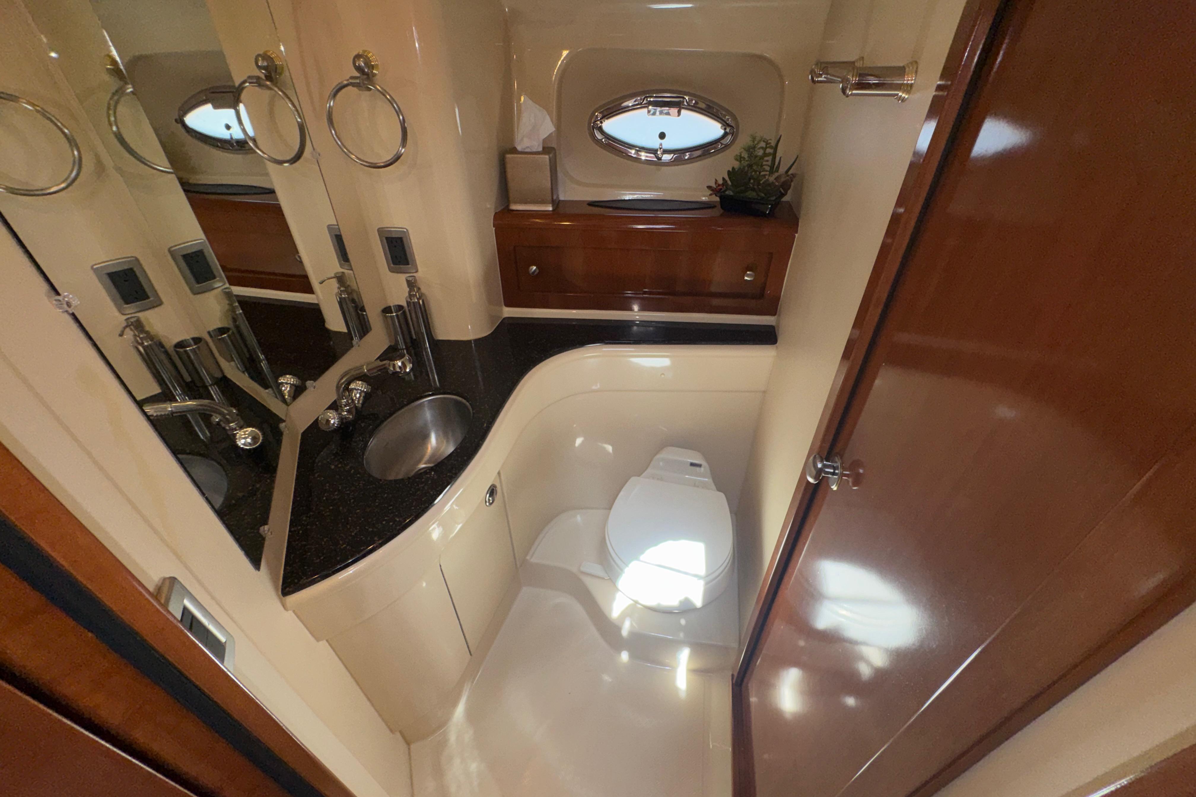 Luxurious bathroom in a 2007 Meridian 411 Sedan yacht with modern fixtures.
