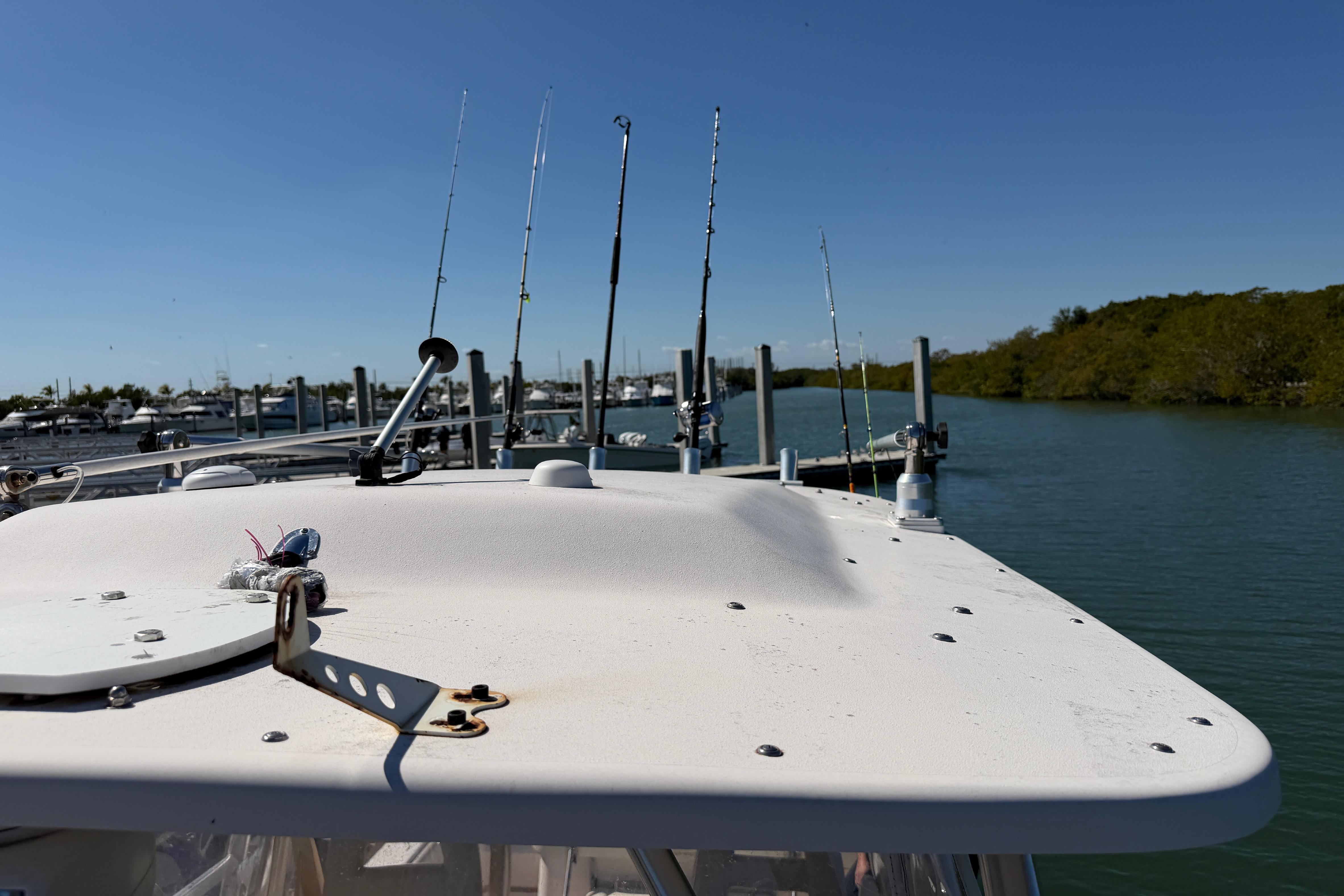 2006 Grady-White Sailfish 282 boat with fishing rods docked in a marina.