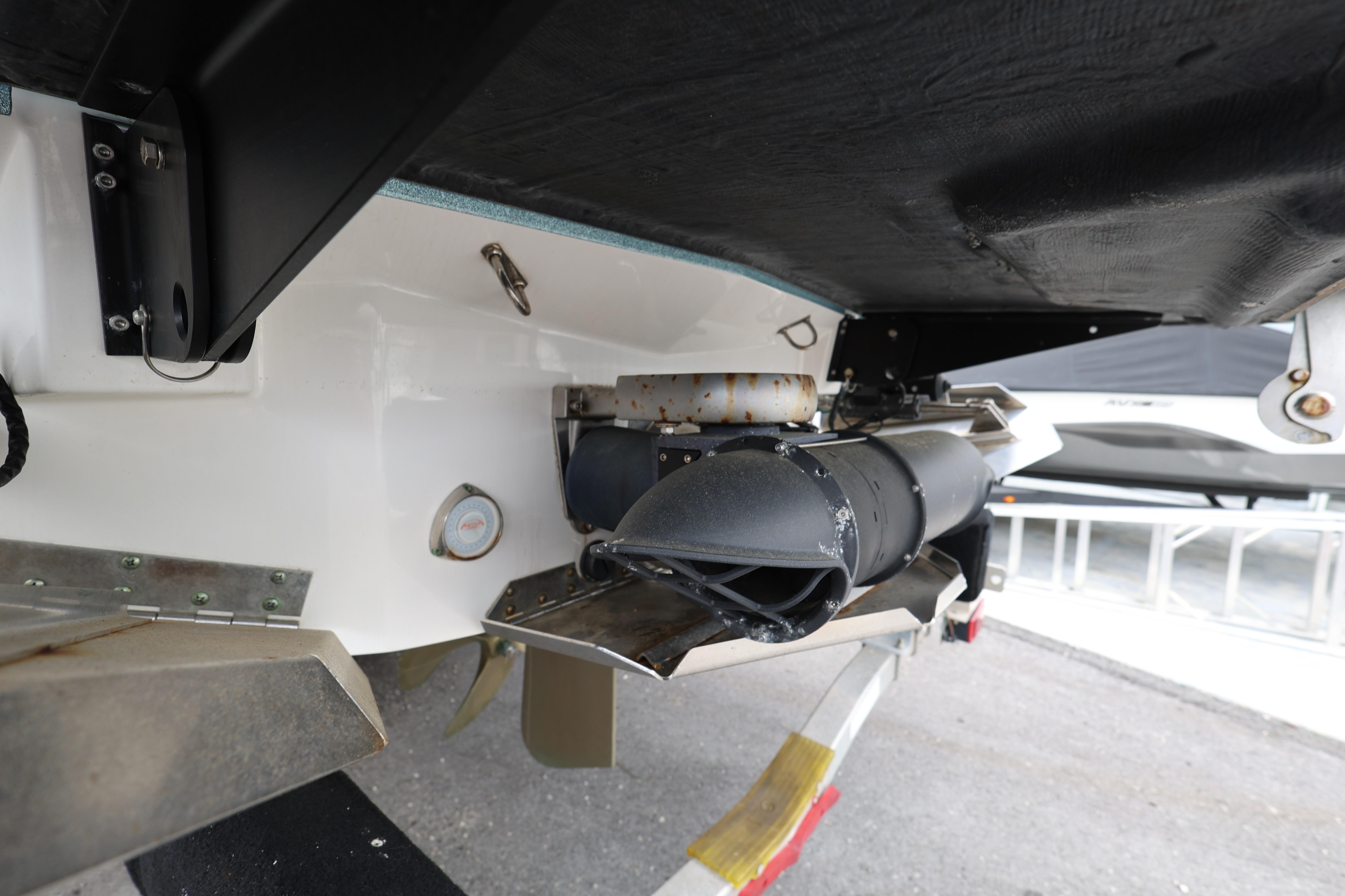 2023 MasterCraft X24 boat underside showing exhaust and propeller components.