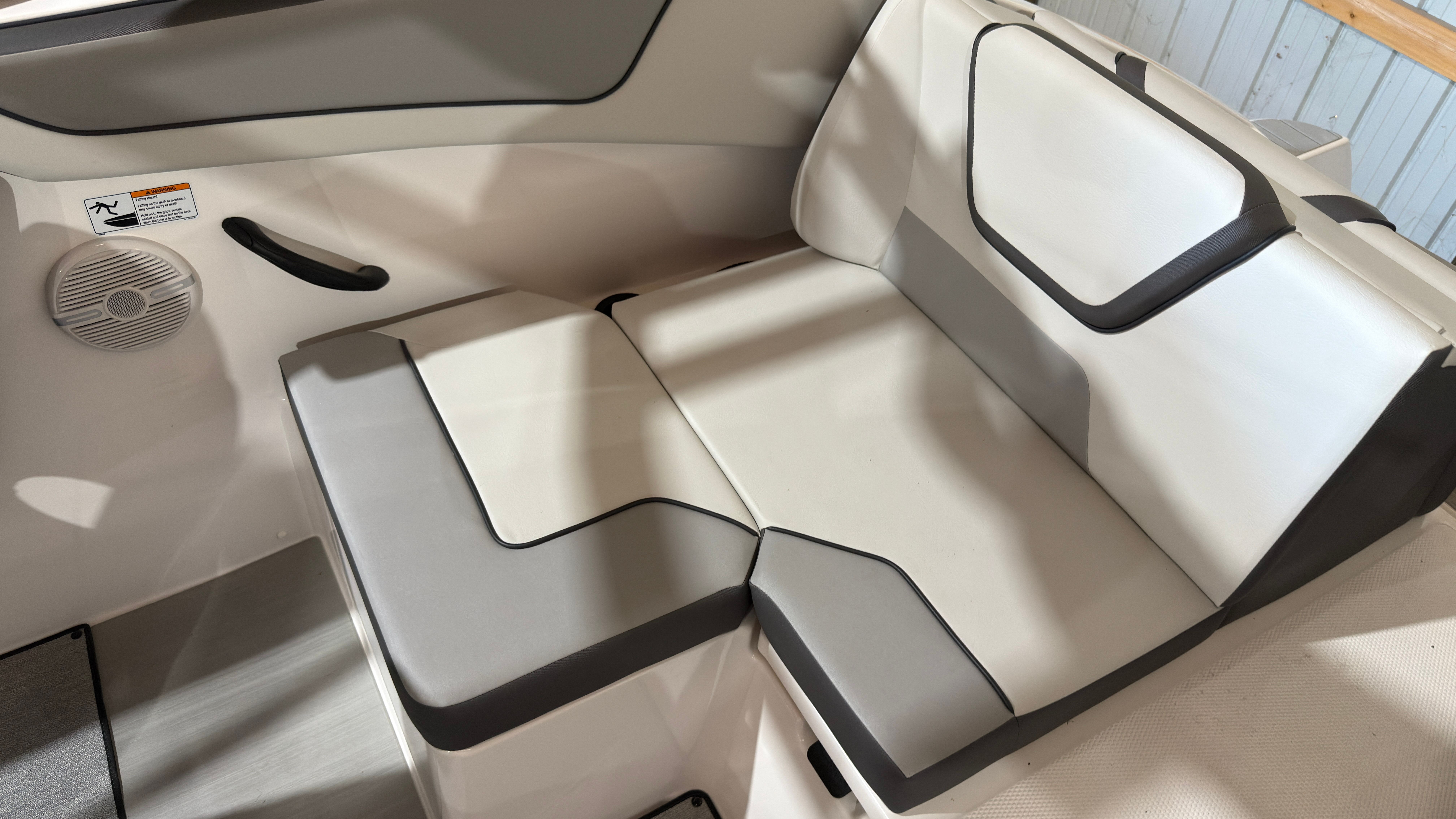 2024 Yamaha AR220 boat interior with beige and gray seating.
