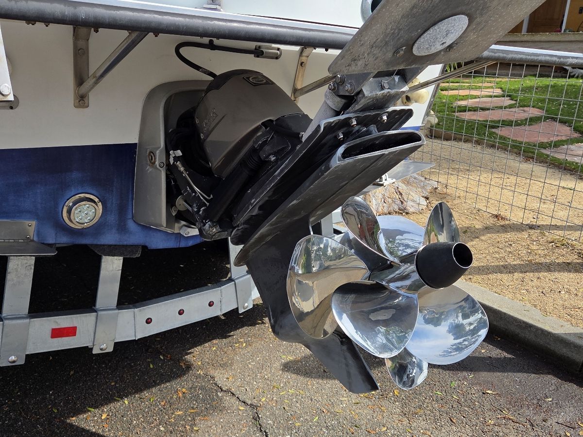 Close-up of a shiny propeller on a boat resting on a trailer.