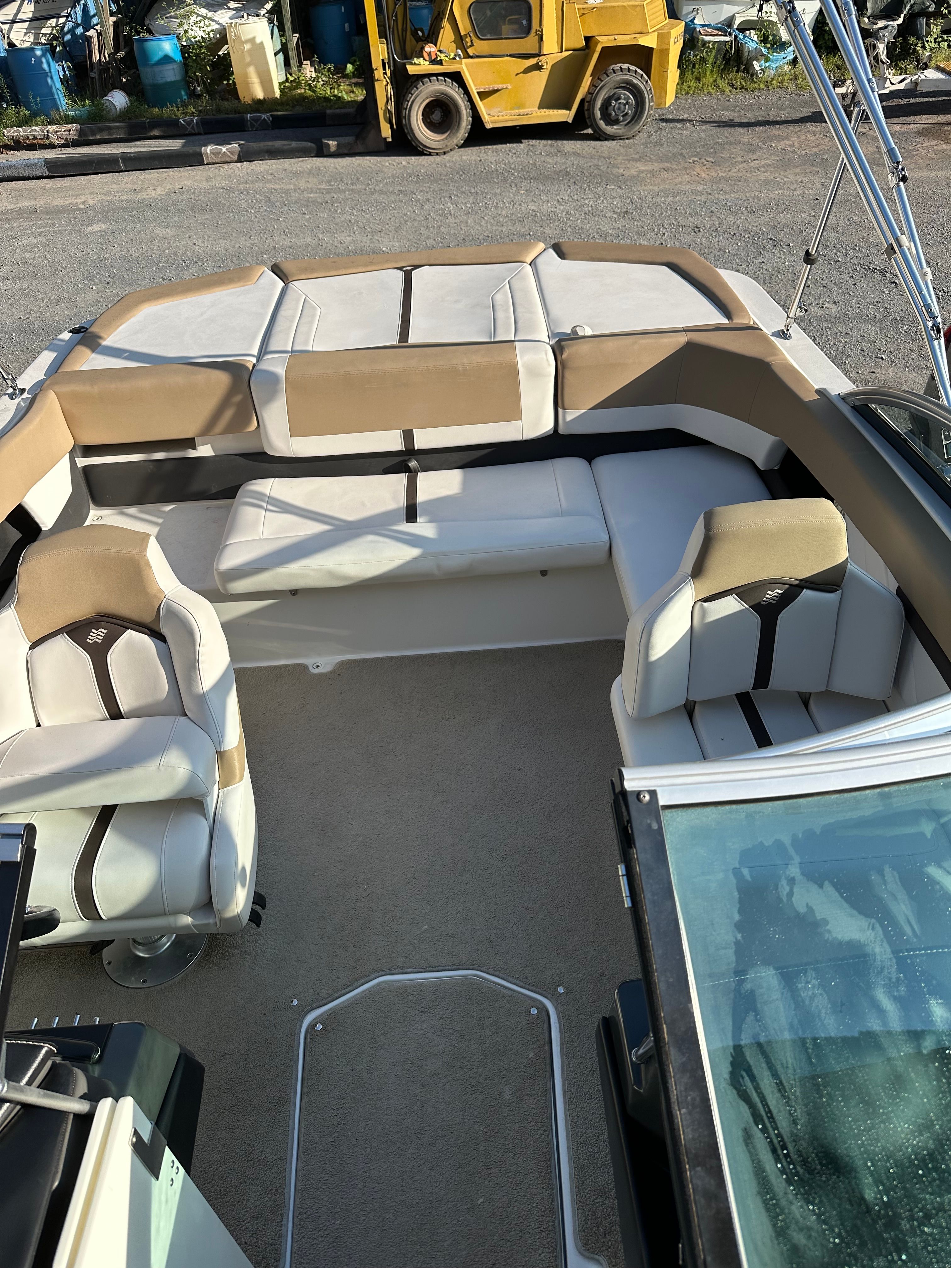 Interior of a 2012 Four Winns H210 boat with beige seating.