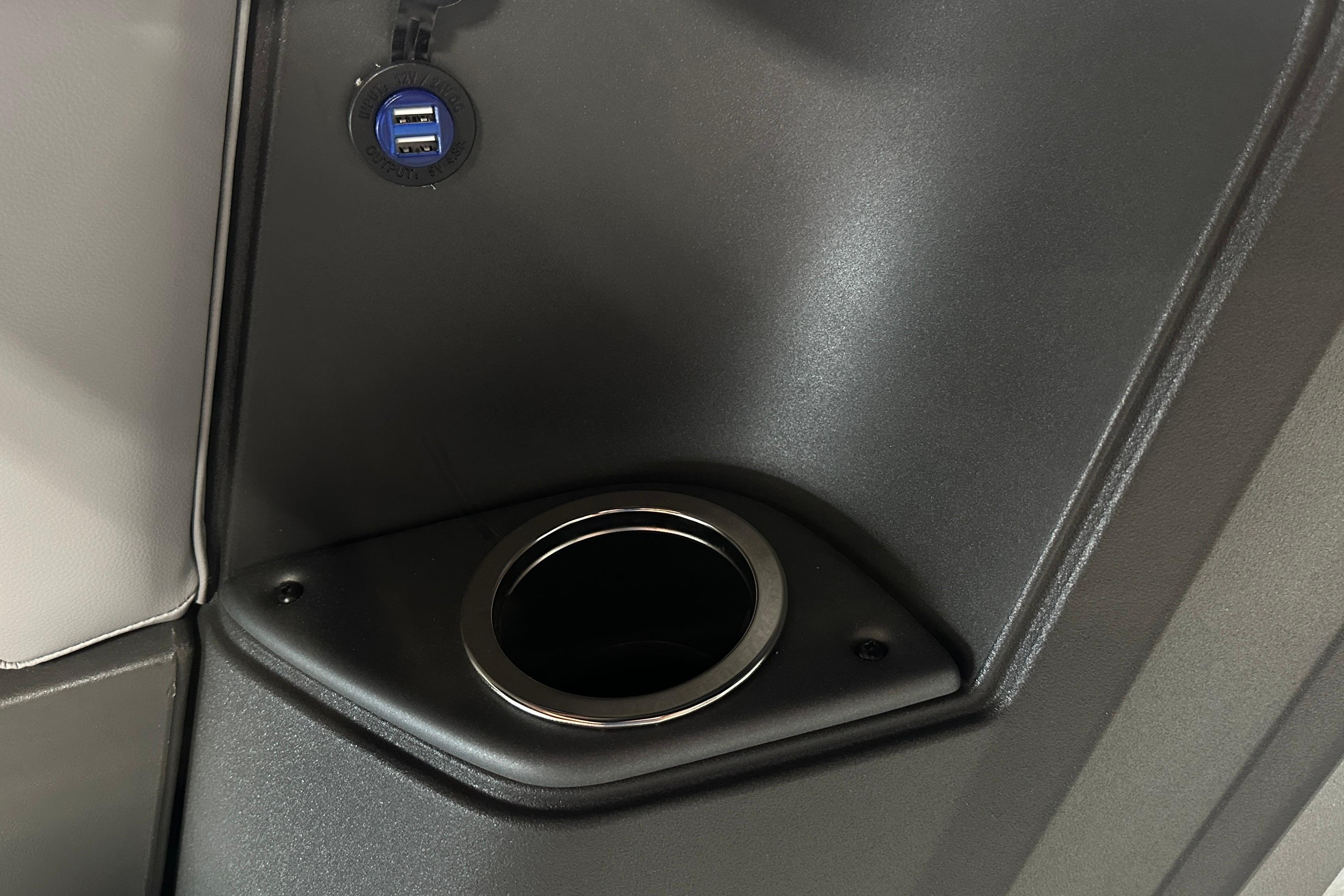Cup holder and USB ports on 2026 Sun Tracker SportFish 22 DLX boat interior.