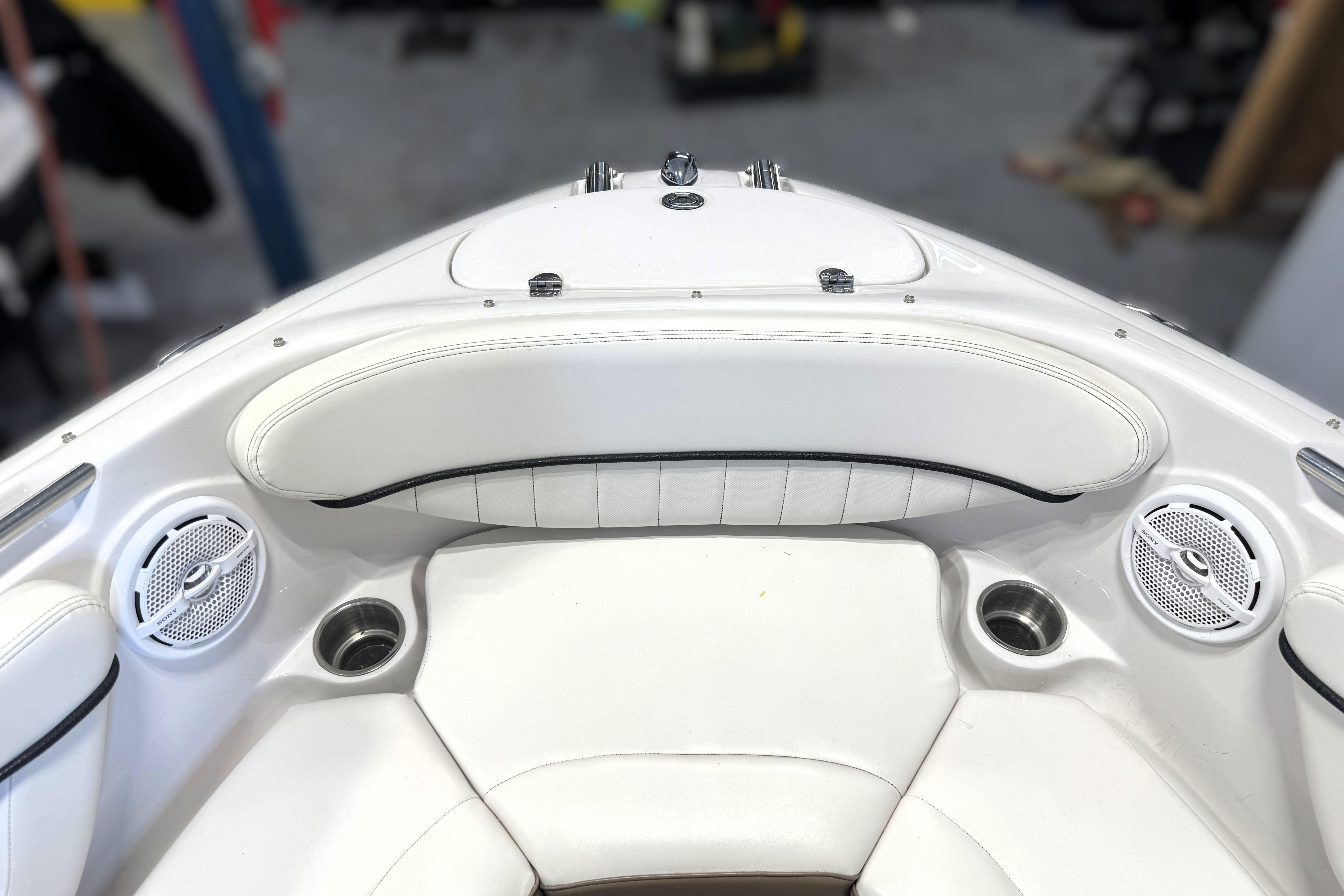 Interior of 2008 Four Winns H240 boat with white seating and built-in speakers.
